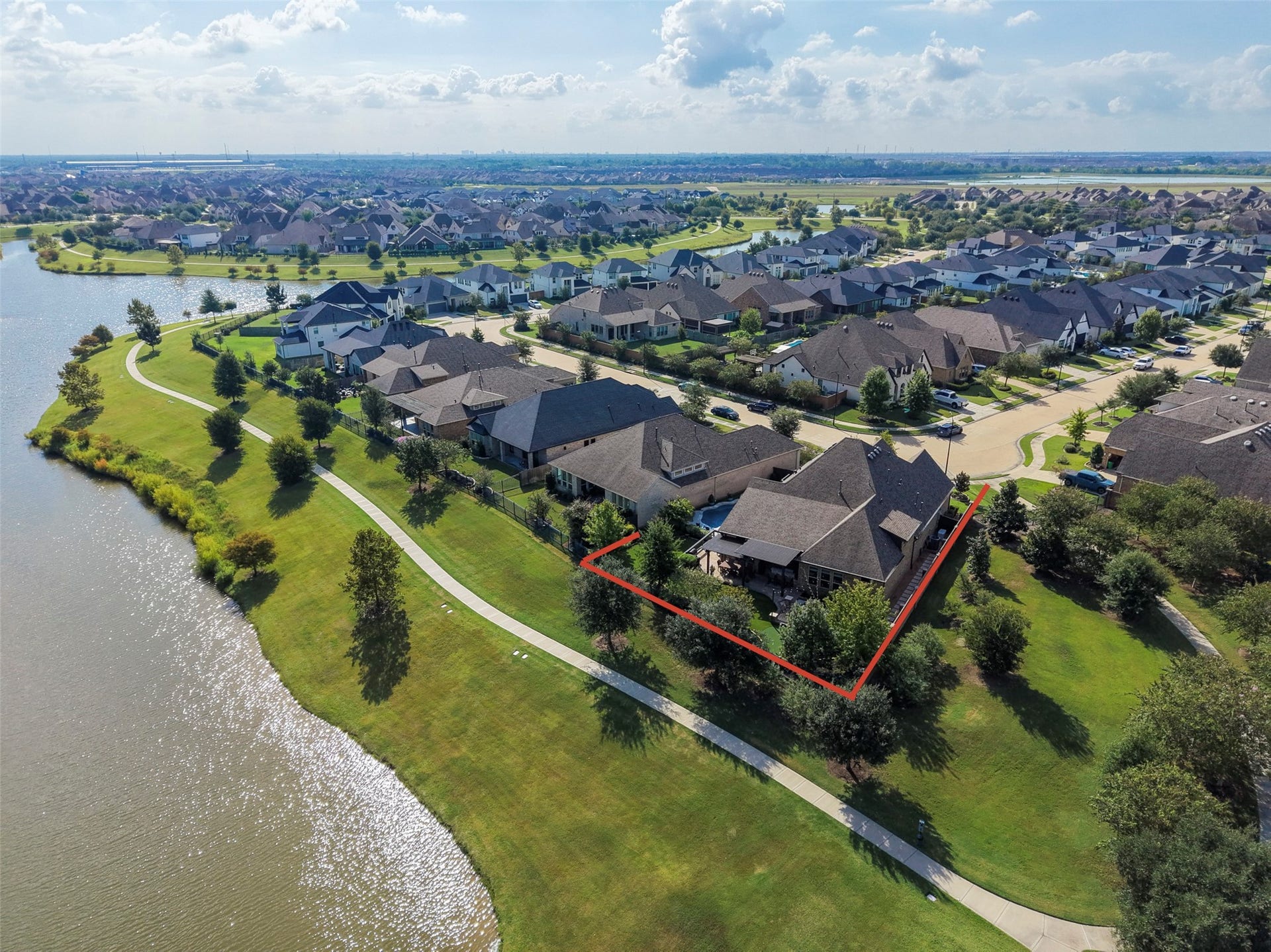 23926 Arcola Glen Lane, Katy, TX 77493 Coveted waterfront location backing to a lush greenbelt with no neighbors to the right or rear, offering exceptional privacy and significant added value to the property.