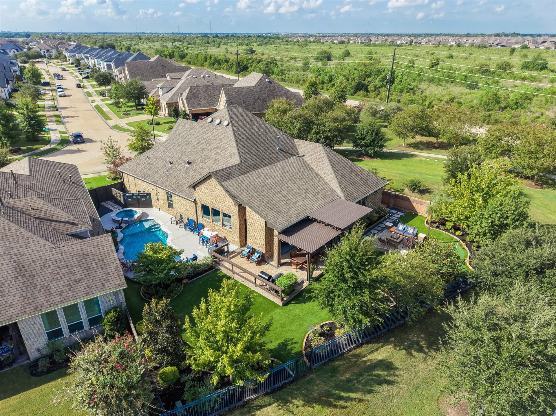23926 Arcola Glen Lane, Katy, TX 77493 This spacious lot offers endless possibilities for outdoor living, featuring ample room for a custom pool and spa. The expansive design includes space for a covered lanai with an outdoor fireplace, a fully equipped outdoor kitchen, a cozy fire pit, and a low-maintenance turf yard complete with a 4-hole putting green.