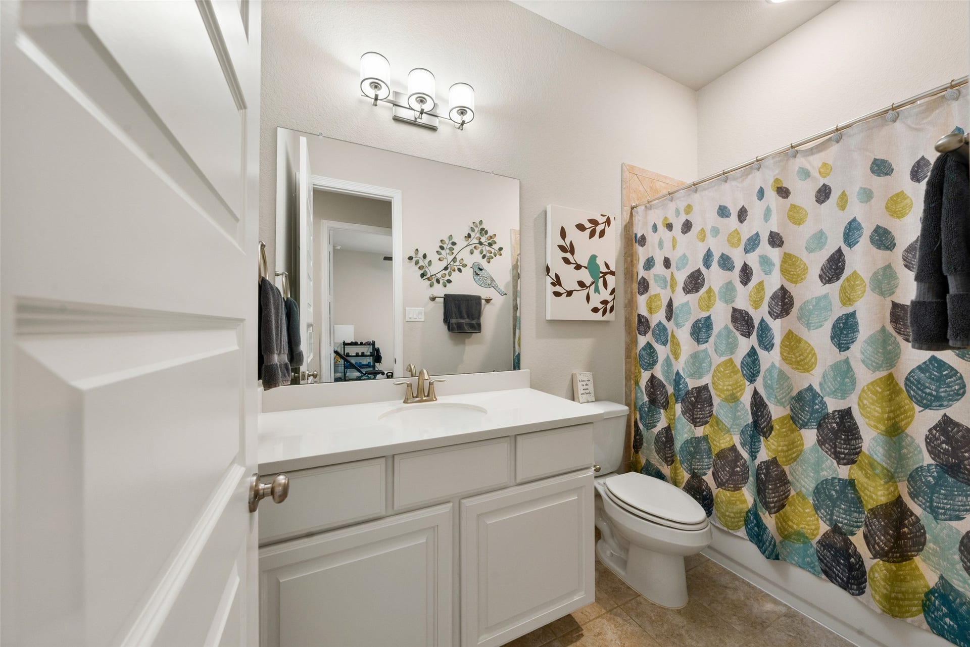 23926 Arcola Glen Lane, Katy, TX 77493 Bright and modern, this third bathroom features a crisp white vanity complemented by sleek silver fixtures and a convenient tub-shower combo.