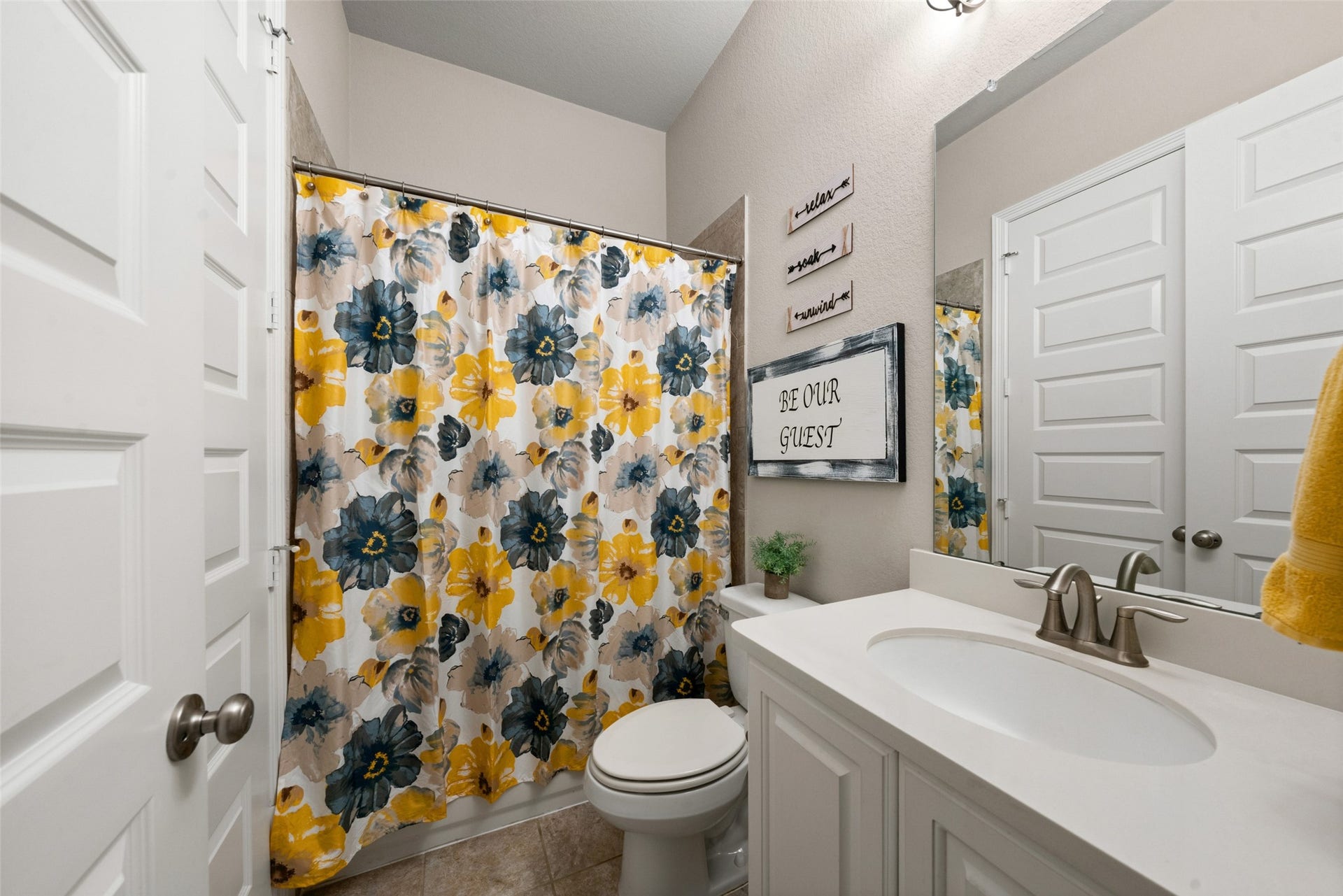 23926 Arcola Glen Lane, Katy, TX 77493 Secondary bathroom featuring a crisp white vanity with modern silver fixtures and a convenient tub/shower combo.
