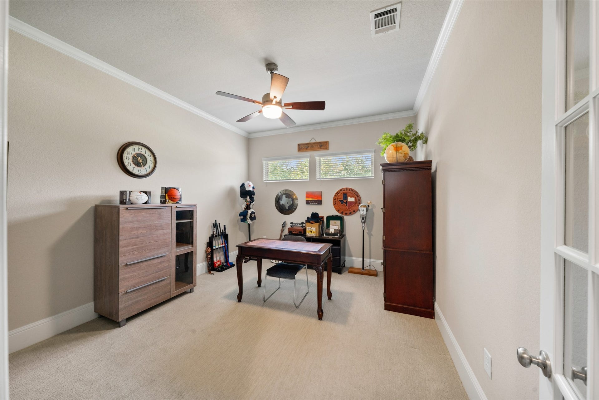 23926 Arcola Glen Lane, Katy, TX 77493 Study/home office featuring high-set windows for enhanced wall space, elegant crown molding, and stylish glass privacy doors.