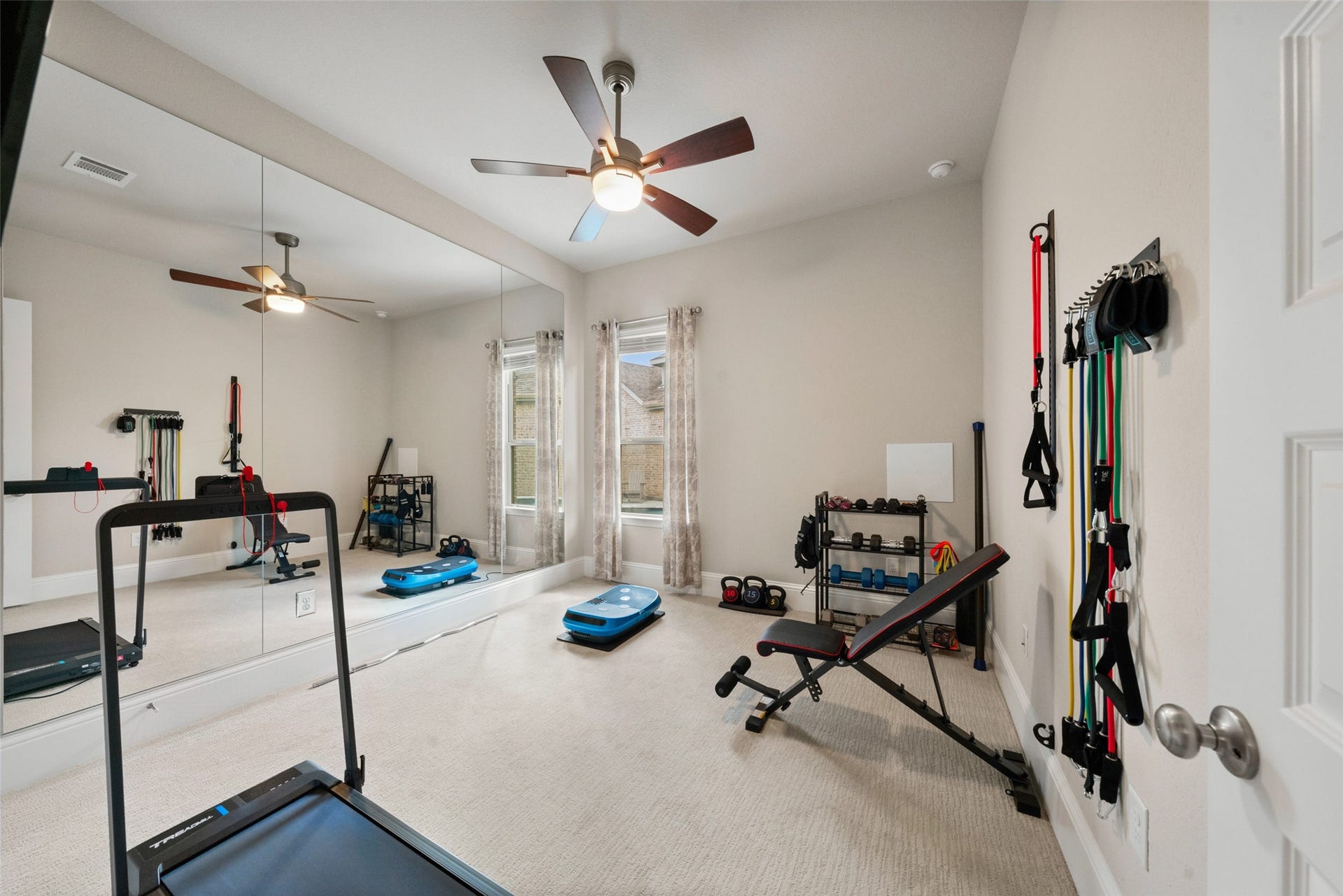 23926 Arcola Glen Lane, Katy, TX 77493 Bedroom 4 has an impressive custom mirrored wall and is currently being used as a home gym.