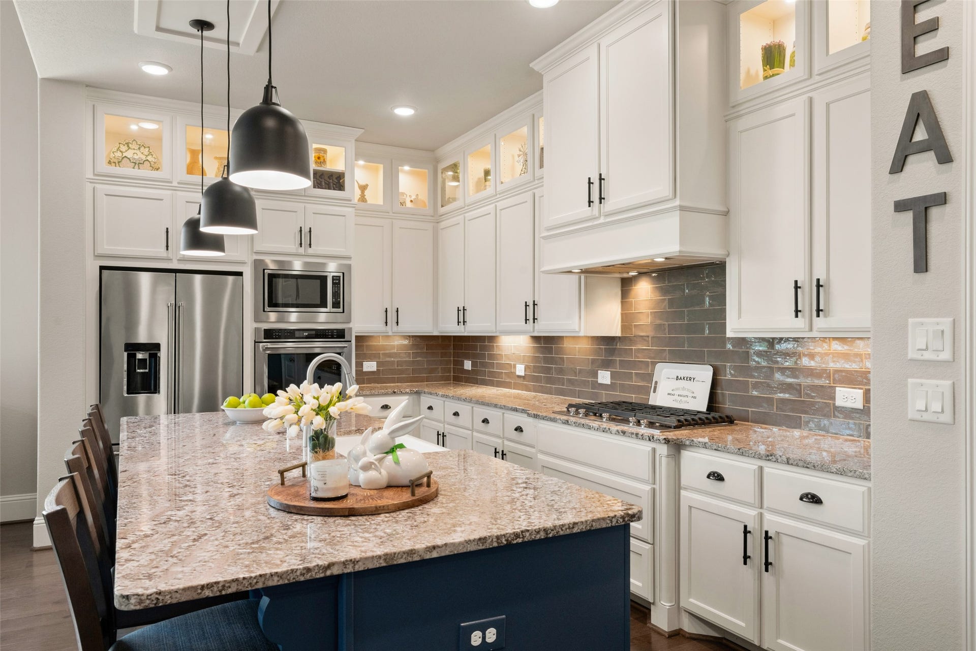23926 Arcola Glen Lane, Katy, TX 77493 Upper cabinets extend to the ceiling, featuring glass-front doors on the top row with integrated LED lighting, perfect for displaying special dishes, glassware, or decorative items.