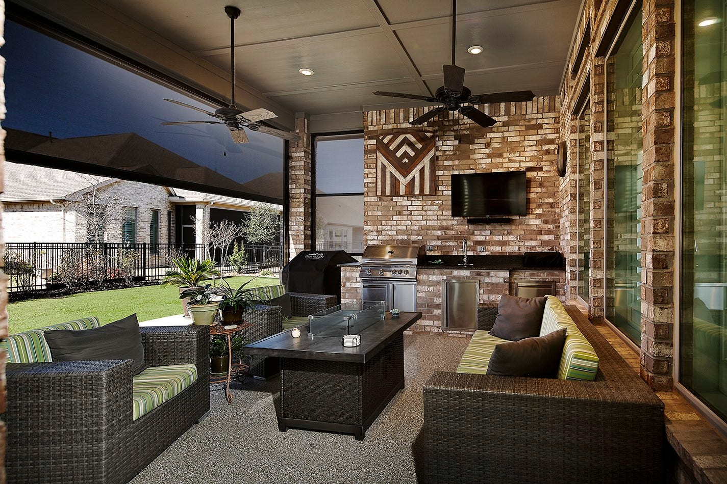 10135 Lehman Drive, Willis, TX 77318 This covered lanai offers a welcoming ambiance, designed for ultimate comfort with electric shades to block the sun and dual ceiling fans.