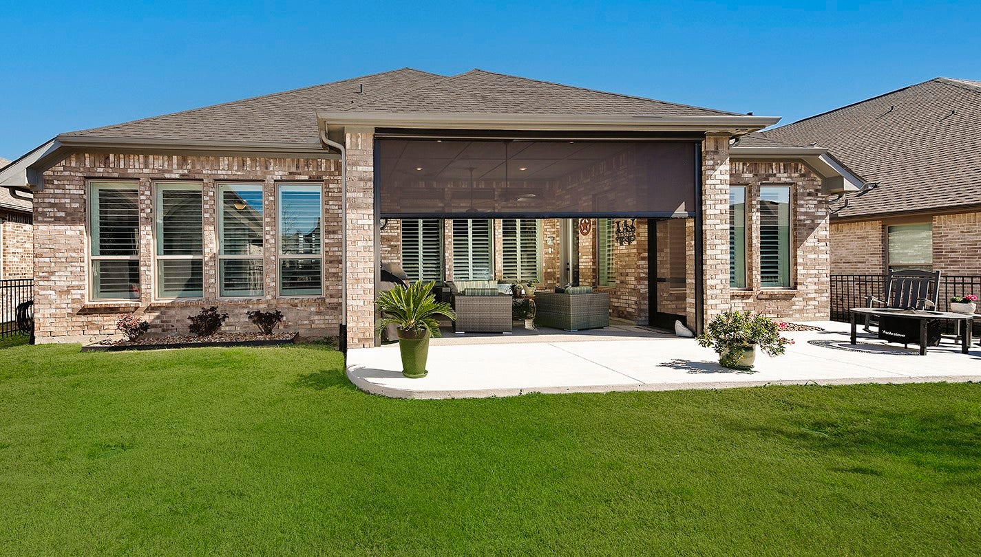 10135 Lehman Drive, Willis, TX 77318 This stunning home features full brick construction on all sides and expansive, floor-to-ceiling windows that span the entire rear elevation.