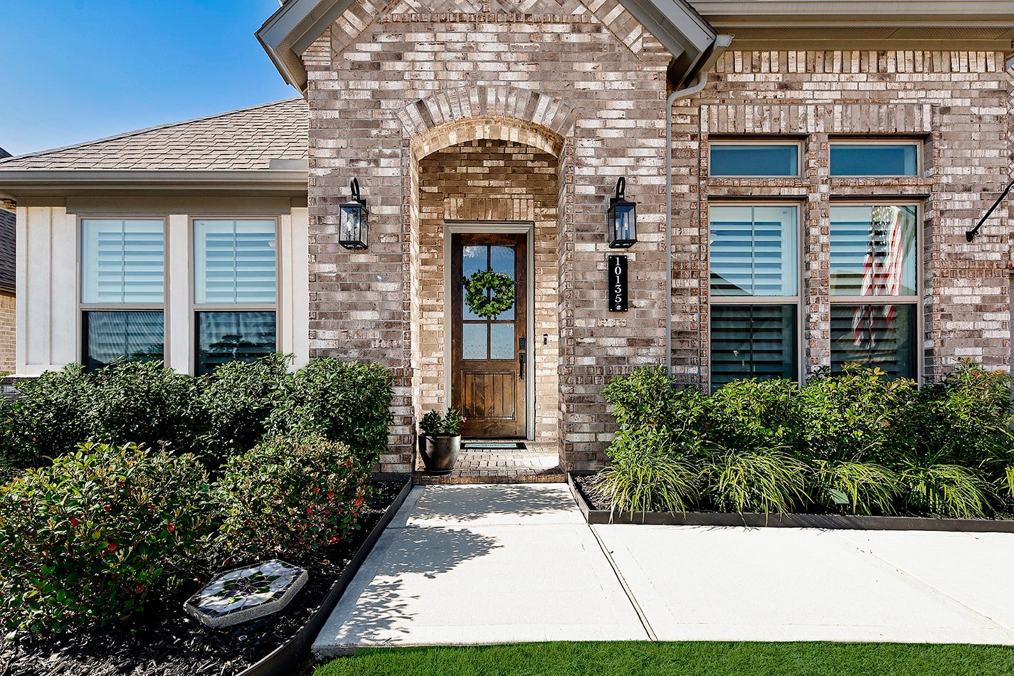 10135 Lehman Drive, Willis, TX 77318 Pristine landscaping adds color, texture, and softness along the front facade, enhancing the property's overall welcoming curb appeal.
