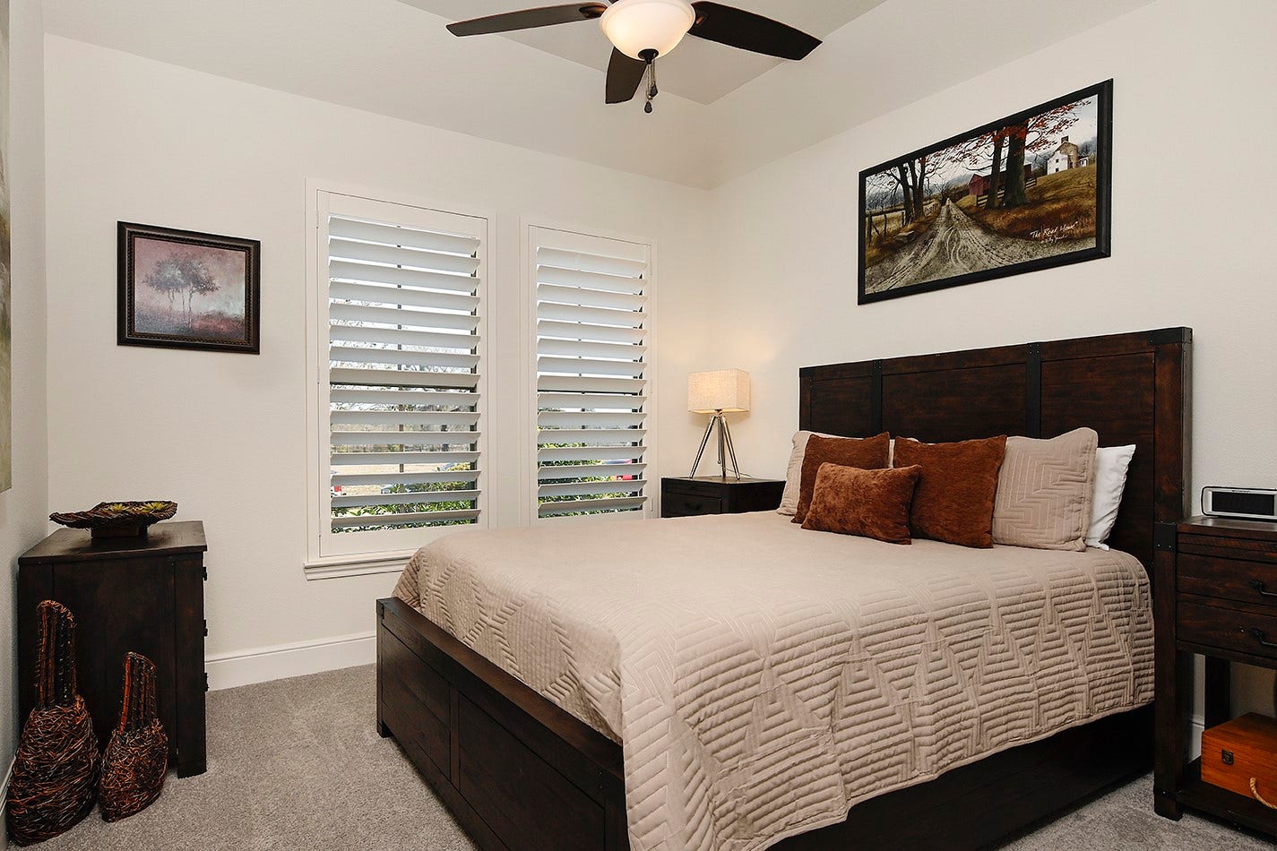10135 Lehman Drive, Willis, TX 77318 Bedroom three has soft neutral colors, plantation shuttered windows, and is spacious in size for a large bed and dressers.
