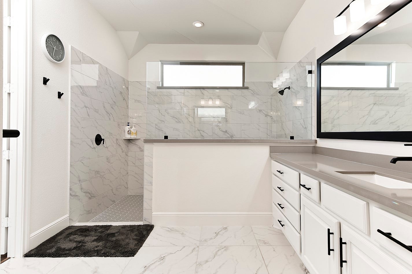 10135 Lehman Drive, Willis, TX 77318 The primary bath has a spacious walk-in shower with glass enclosure and gorgeous marble tile selections.