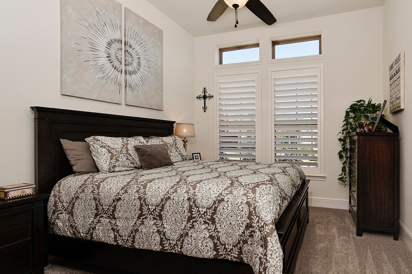 10135 Lehman Drive, Willis, TX 77318 Bedroom two has neutral wall colors to go with any decor, ample room for a large bed and dressers, enhanced by plantation shutters and elegant transom windows.