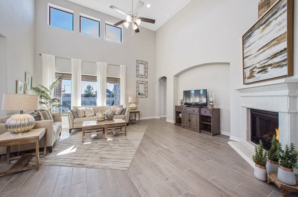 13201 Anchor Bay Drive, La Marque, TX 77568 Spacious living room with high ceilings, abundant natural light, and a cozy fireplace.