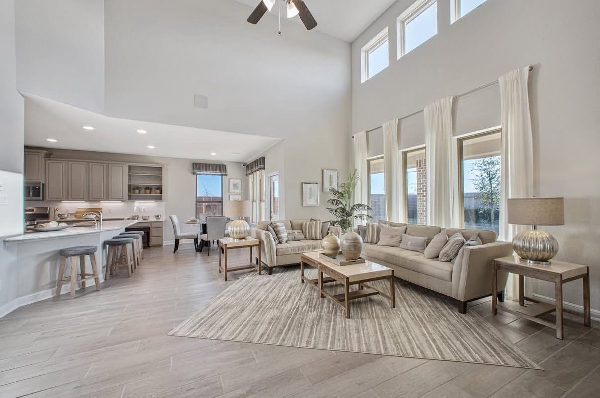 13201 Anchor Bay Drive, La Marque, TX 77568 Spacious living area with vaulted ceilings, abundant natural light, and an open floor plan seamlessly connecting to a modern kitchen with a breakfast bar.