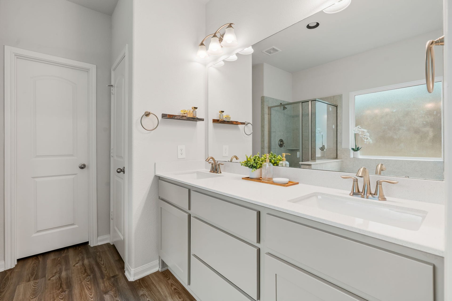 16680 Rockwall Street, Conroe, TX 77303 Double sinks and a walk-in closet with shelving.