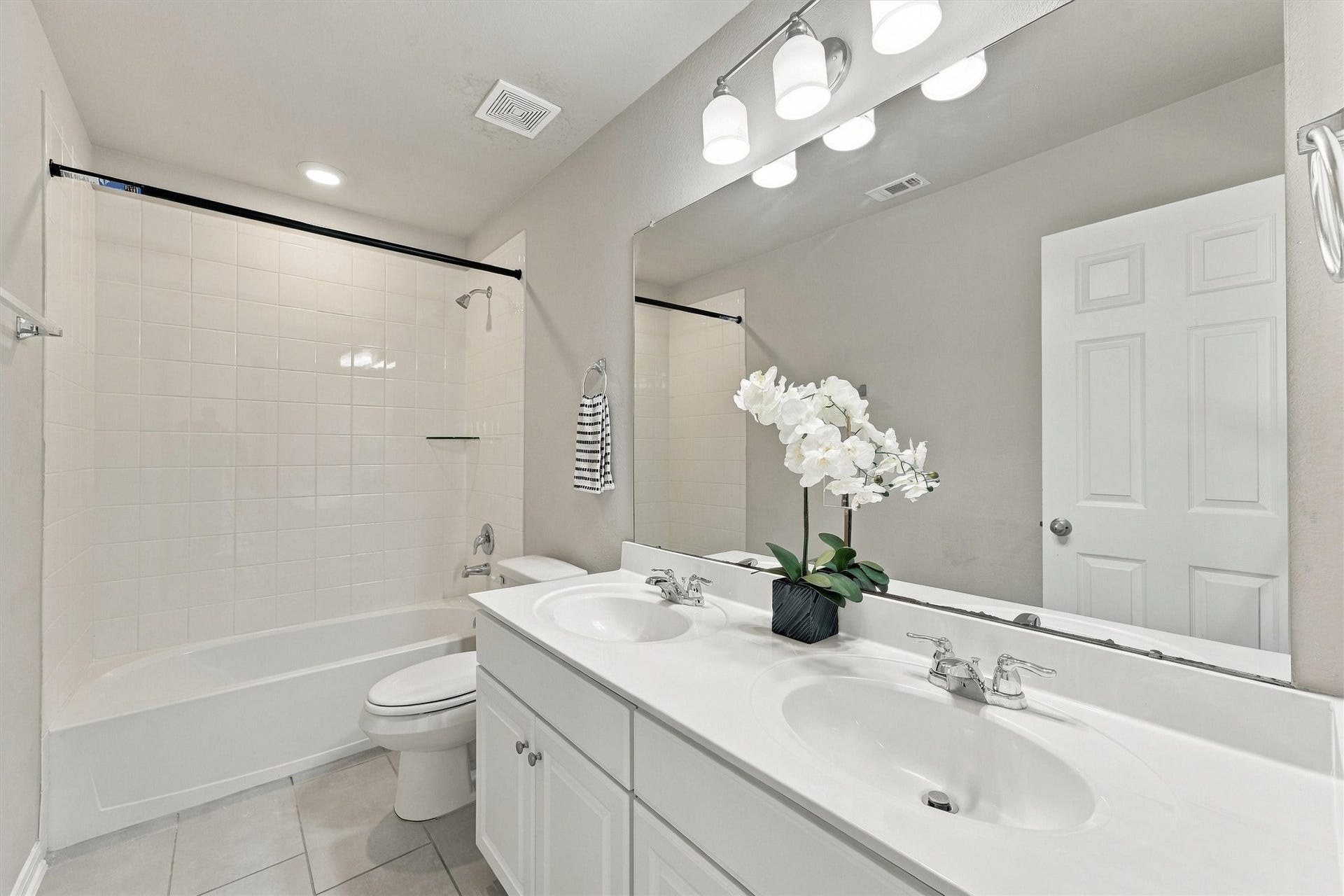 Secondary bathroom featuring a vanity and tub/shower combination.