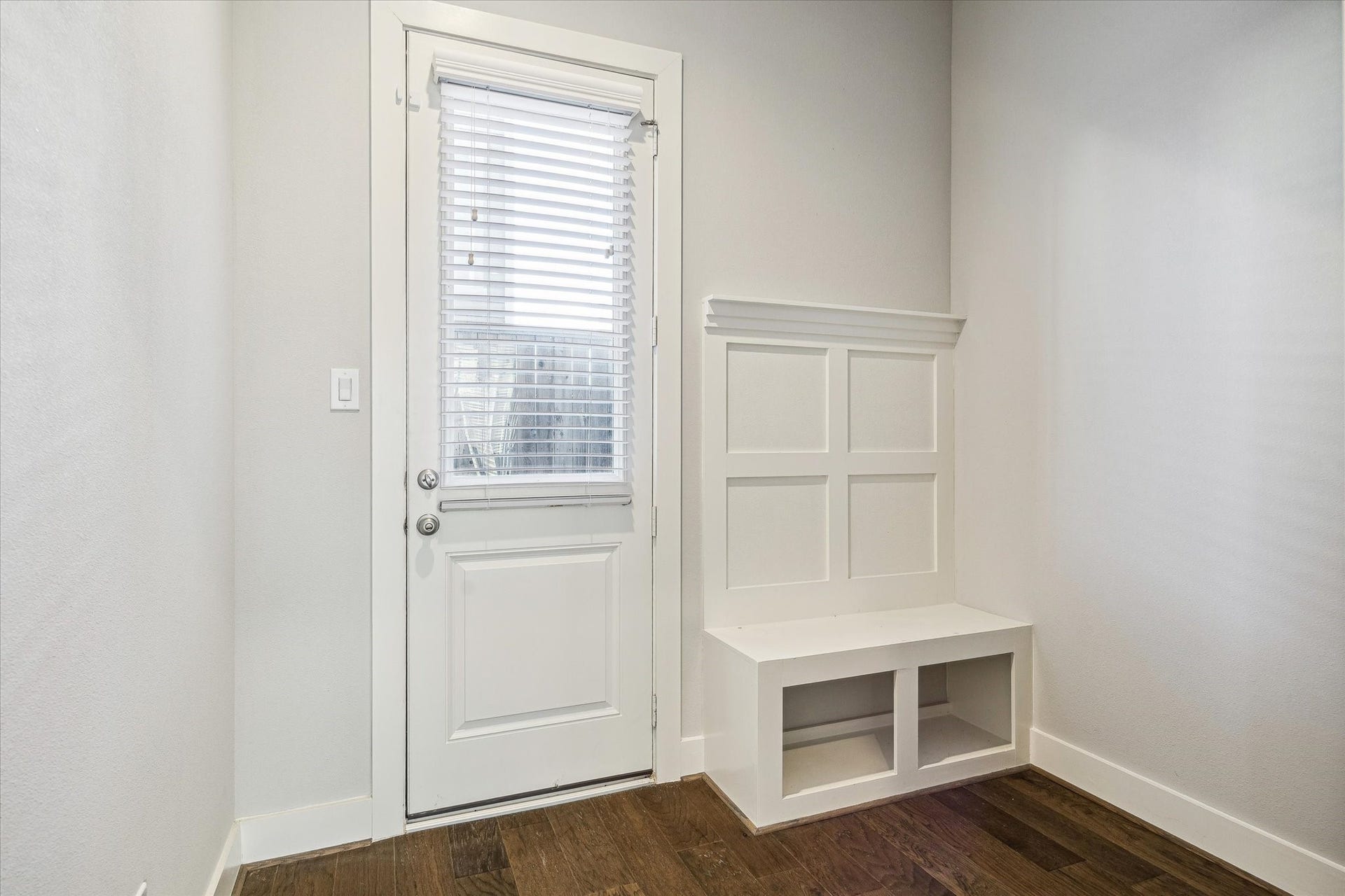 Just passed, and under the stairs, is access to the back patio and this Mudroom area.