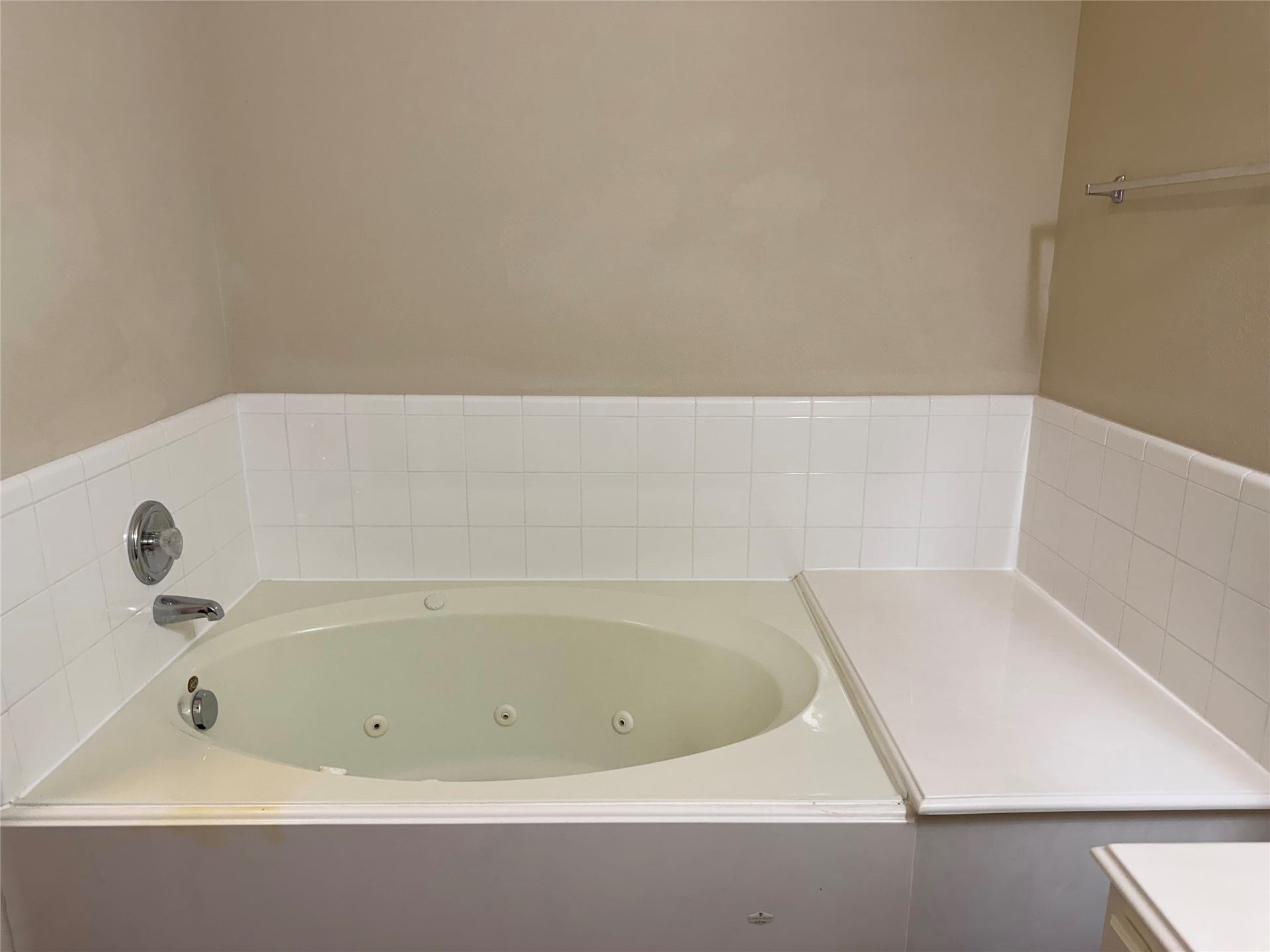 2104 Goldfinch Lane, League City, TX 77573 Luxurious bathtub with sleek fixtures and elegant tile surround, perfect for relaxation.