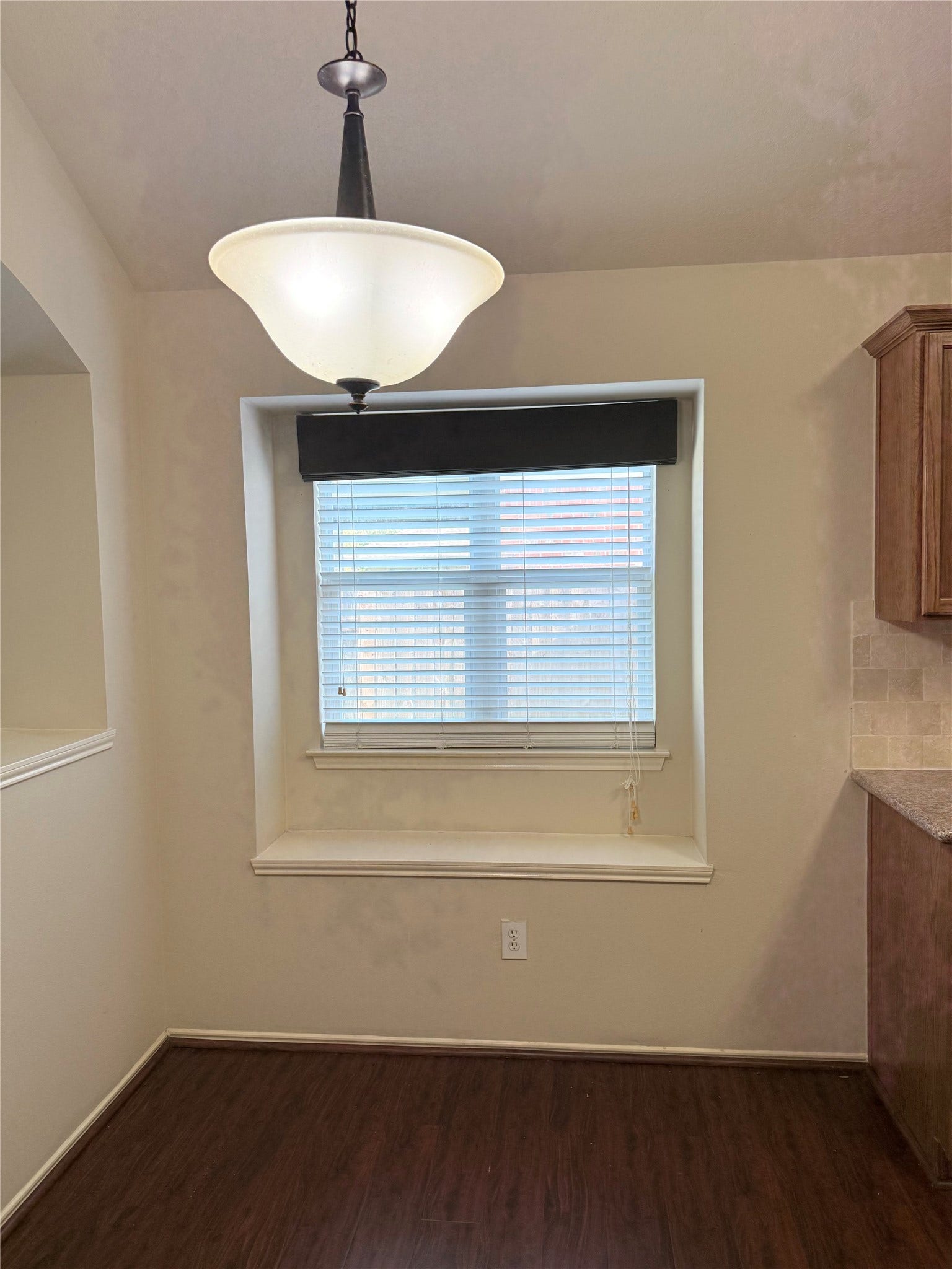 2104 Goldfinch Lane, League City, TX 77573 Cozy dining nook with a large window seat, elegant pendant lighting, and warm wood flooring, perfect for intimate meals.