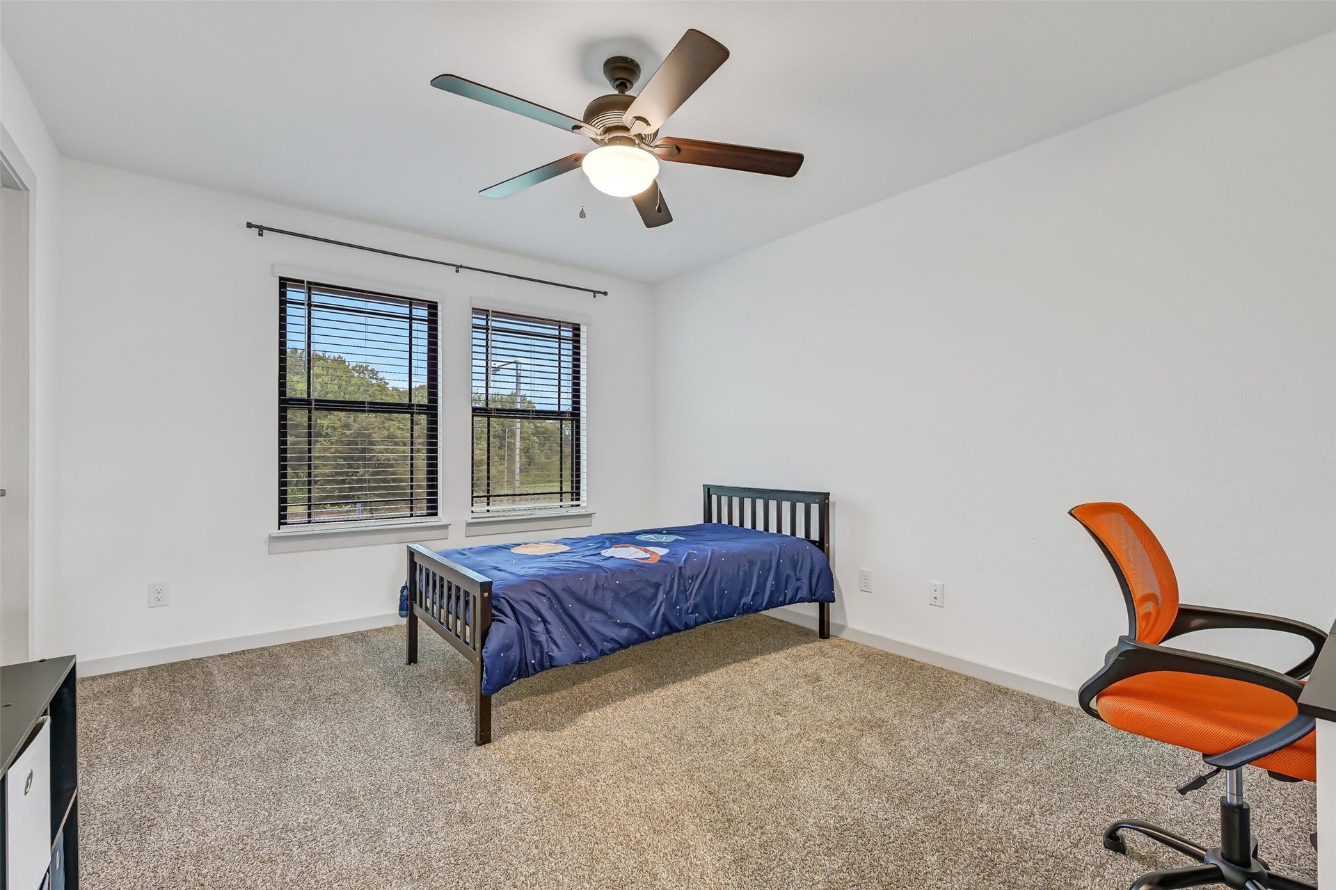 1570 Mustang Trail, Friendswood, TX 77546 Another roomy secondary bedroom offers two large windows, plush carpet, a ceiling fan, and plenty of wall space for furniture. All secondary bedrooms are located upstairs near the game room and two full baths for a functional, well-planned layout.