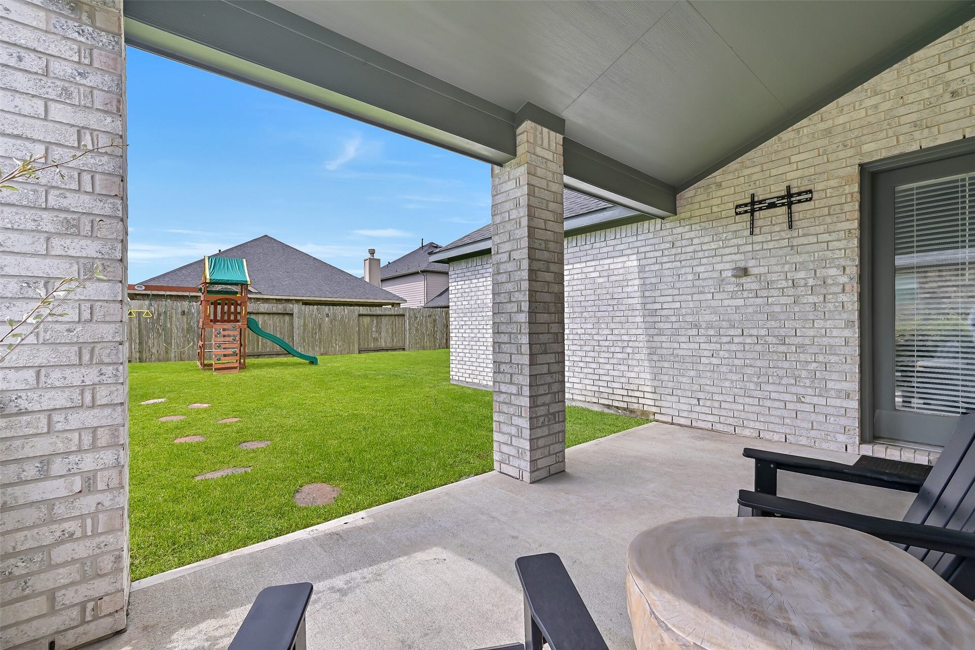 1570 Mustang Trail, Friendswood, TX 77546 Step outside to a covered back patio that extends the home's usable living space outdoors, with plenty of room for seating and a clear view across the fully fenced backyardan inviting shaded spot for morning coffee or unwinding at the end of the day.