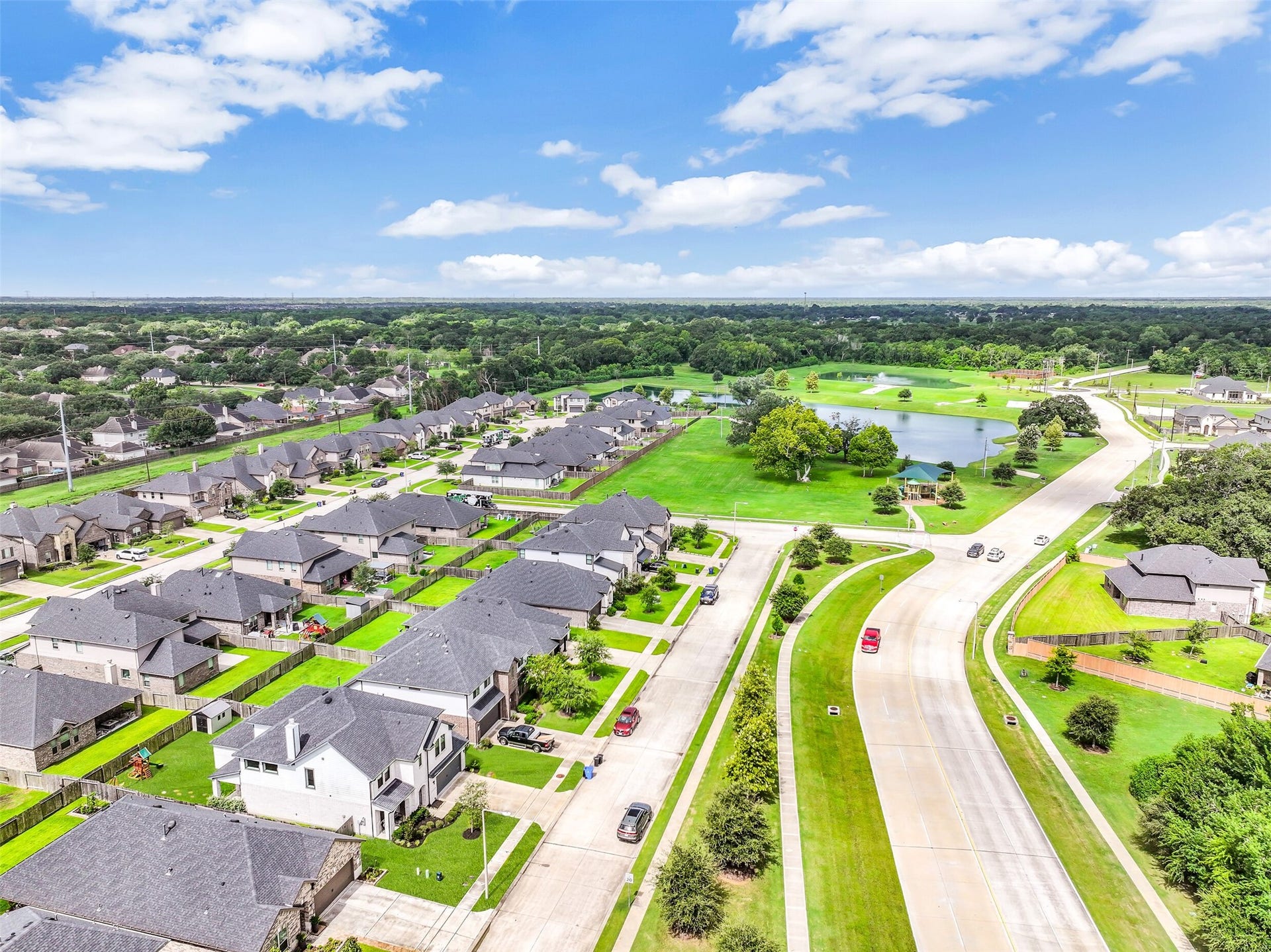 1570 Mustang Trail, Friendswood, TX 77546 A bird's-eye view highlights the home's convenient position within Friendswood Trails, with neighborhood green space, walking paths, playground, and lake all nearbybringing recreation and outdoor amenities within easy reach.