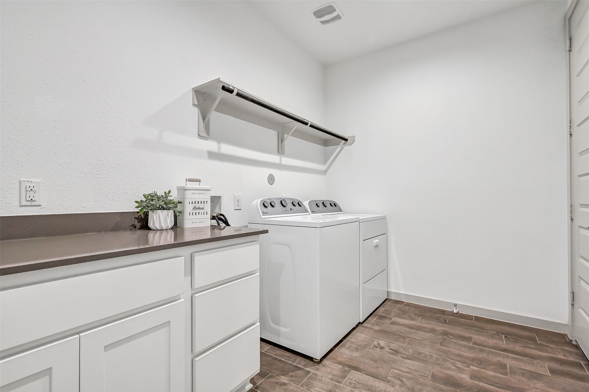 1570 Mustang Trail, Friendswood, TX 77546 Even the utility room offers plenty of function, with generous floor space, built-in cabinetry and counter space for folding or storage, a hanging rod, and durable wood-look tile flooring. Conveniently located on the first floor.