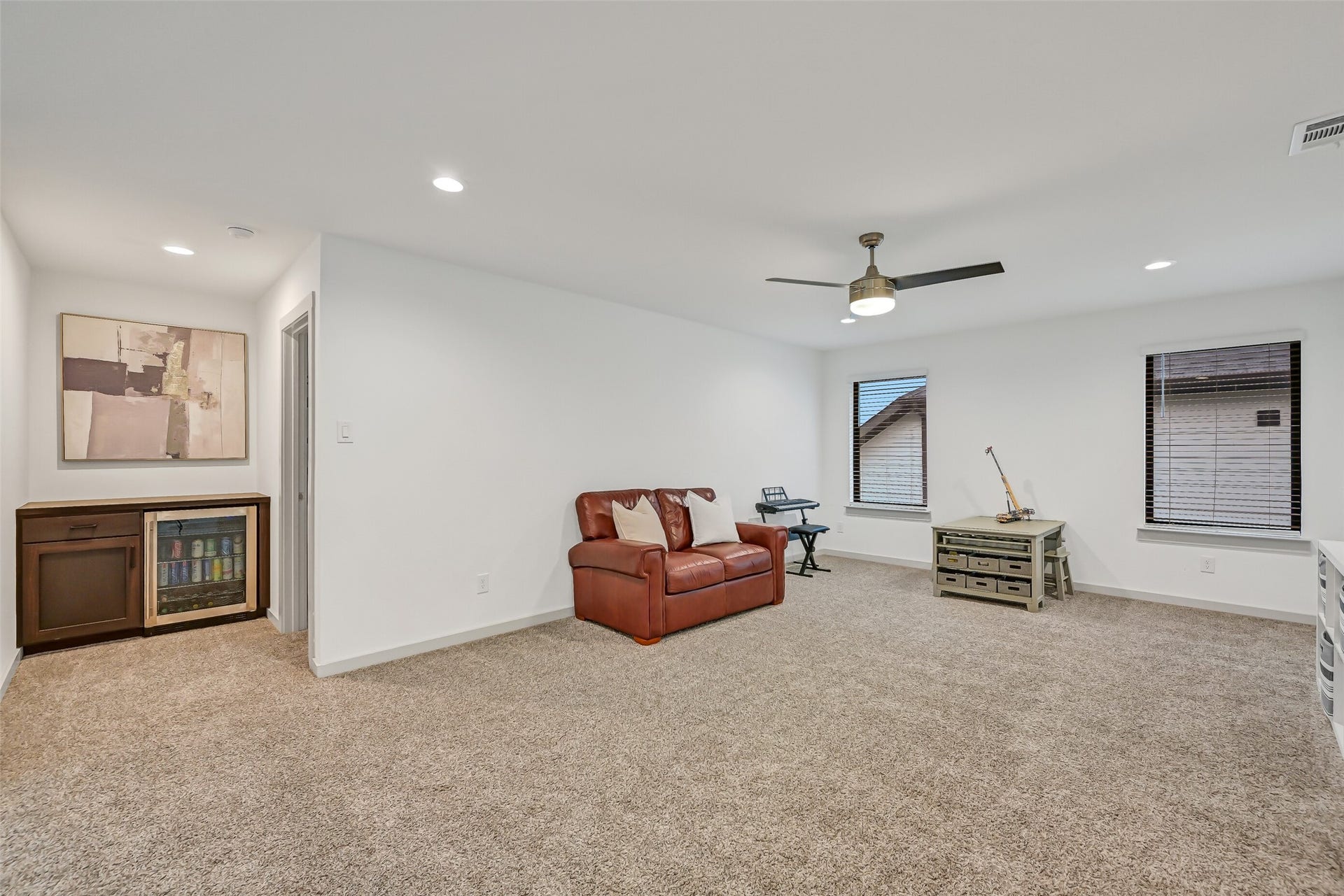 1570 Mustang Trail, Friendswood, TX 77546 Generously sized and wonderfully flexible, the upstairs game room easily accommodates multiple activity or seating zones. A built-in beverage center with cabinetry and beverage refrigerator adds an unexpected convenience for movie nights, games, or entertaining.
