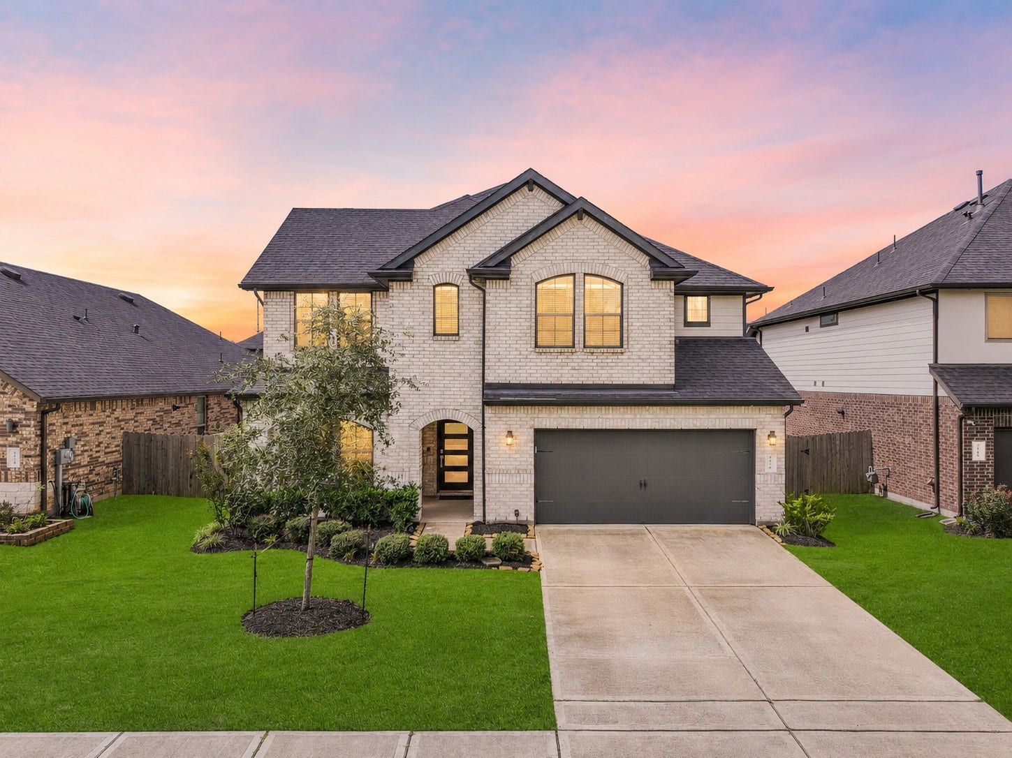 1570 Mustang Trail, Friendswood, TX 77546 Beautifully maintained D.R. Horton Chloe floor plan in Friendswood Trails, featuring a handsome light-brick exterior with contrasting dark trim, manicured landscaping, mature greenery, and a welcoming covered entryall zoned to sought-after Friendswood ISD.