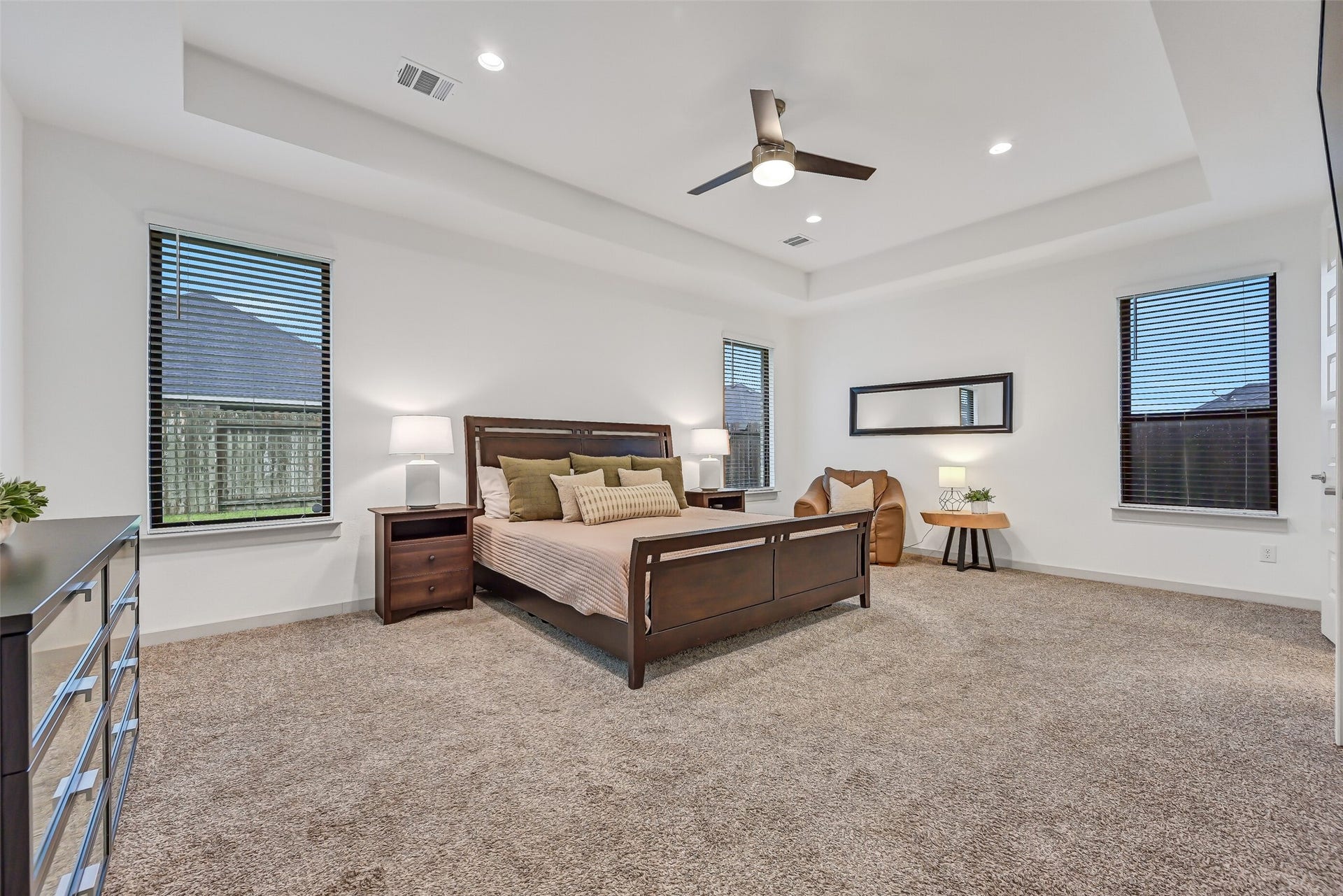 1570 Mustang Trail, Friendswood, TX 77546 Tucked away on the first floor, the oversized primary suite provides a peaceful retreat with a tray ceiling, recessed lighting, ceiling fan, multiple windows, and plenty of space for a substantial bedroom set plus a comfortable sitting area.