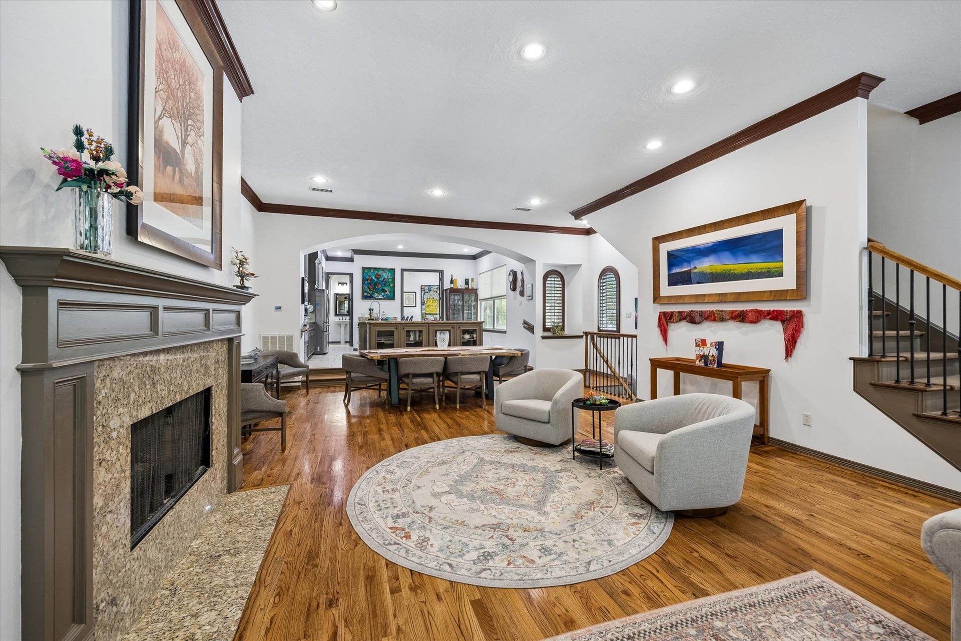 Just beyond the Den is a Sitting Room anchored by the wood burning, gas log Fireplace.