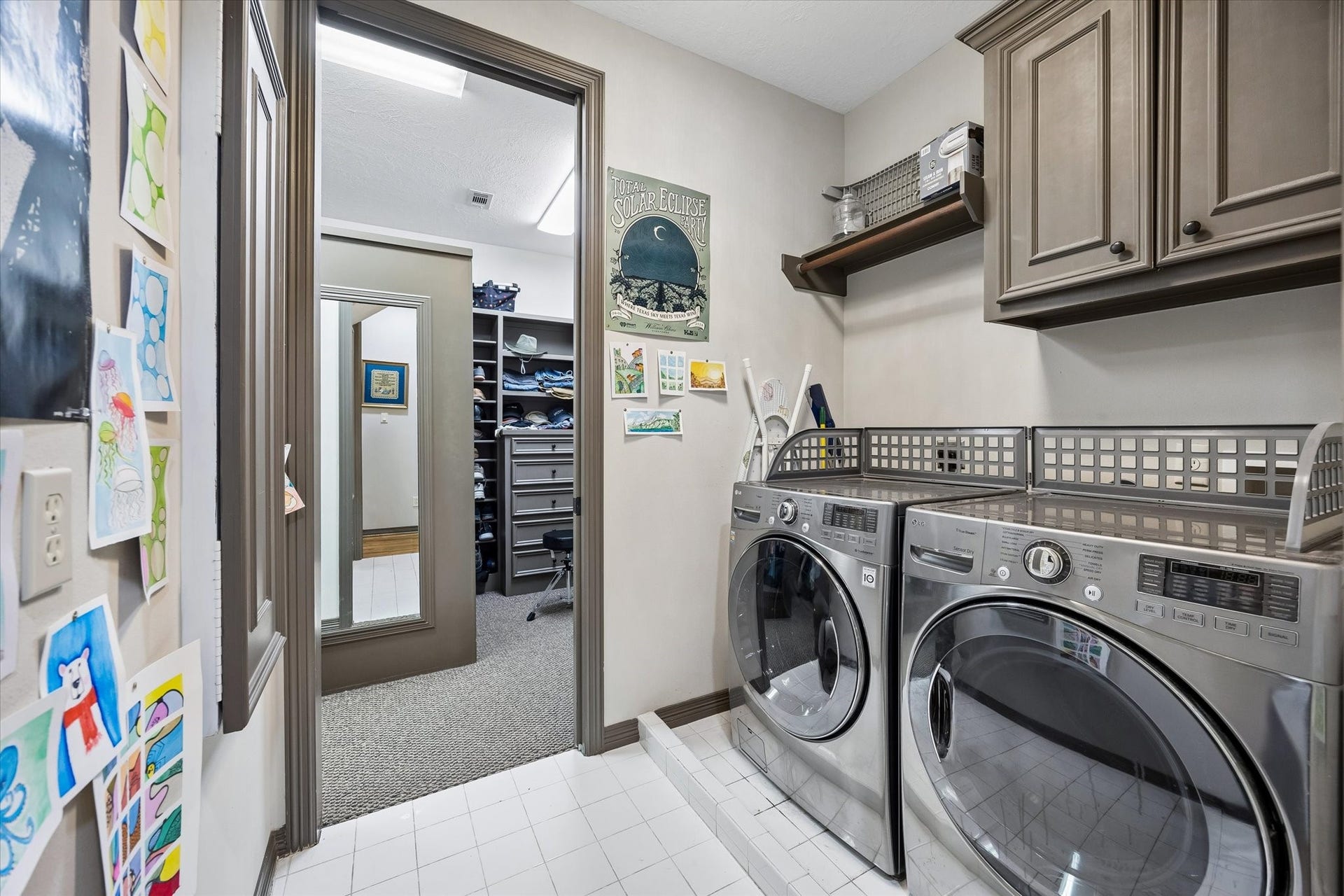 Just off the Master Closet is the Utility Room with cabinets, drip dry hanging space and a built-in ironing board.
