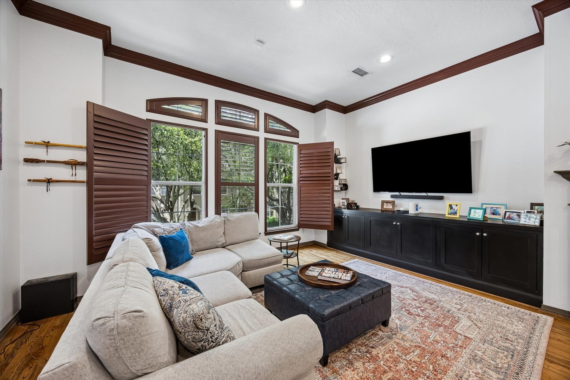 The Den features plantation shutters and a built-in cabinet for your electronics.  Check out that treetop view!