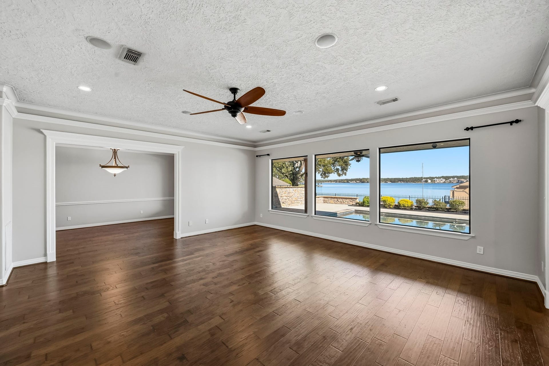 9354 Escondido Drive, Willis, TX 77318 Natural light fills this inviting gathering space, where an open layout connects the living and formal dining areas.