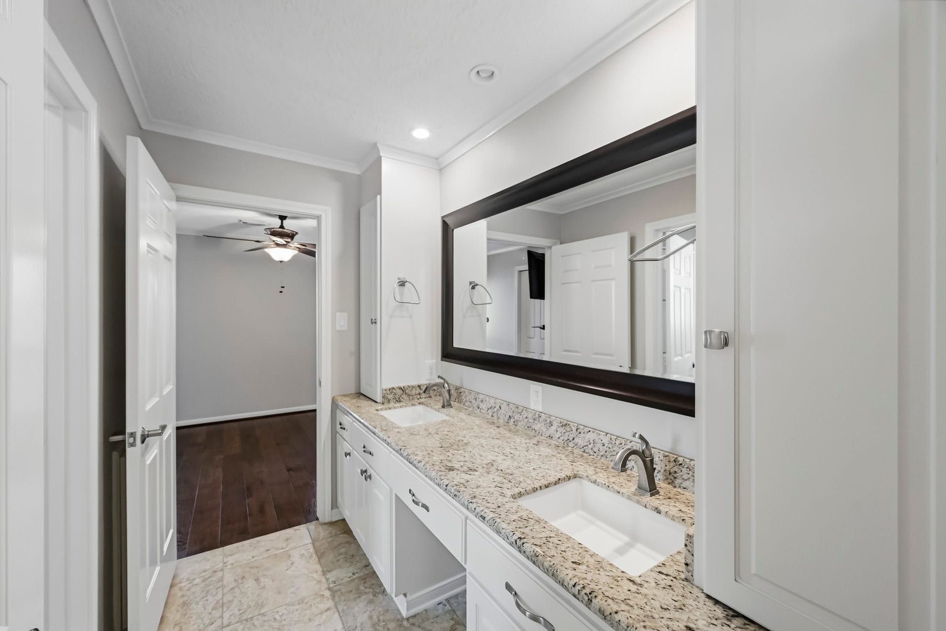 9354 Escondido Drive, Willis, TX 77318 Bath #4. Jack and Jill Bathroom with an extended vanity and dual sinks, granite countertops, and white cabinetry.
