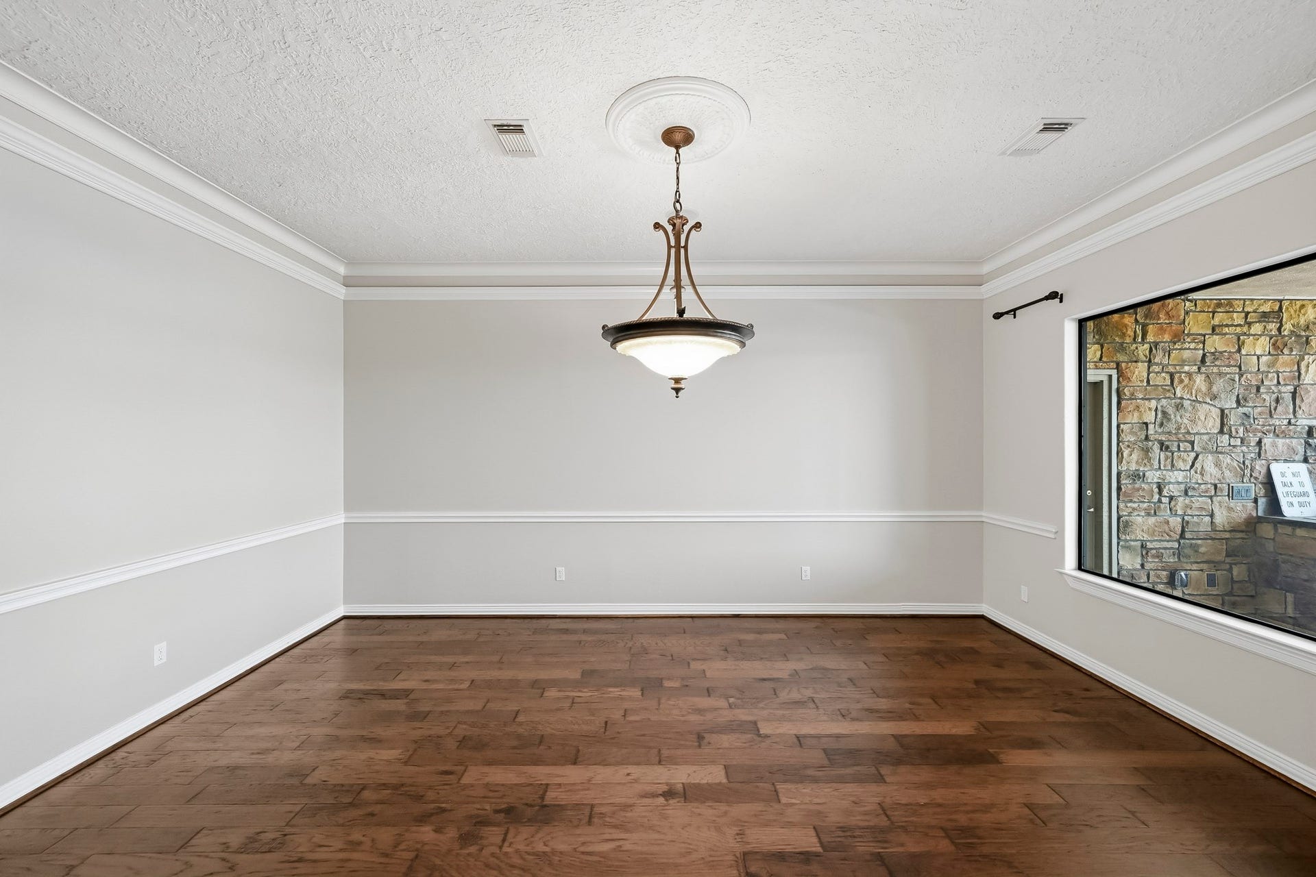 9354 Escondido Drive, Willis, TX 77318 The formal dining room features crown molding, chair rail detailing and a decorative chandelier, creating an elegant setting for gatherings.