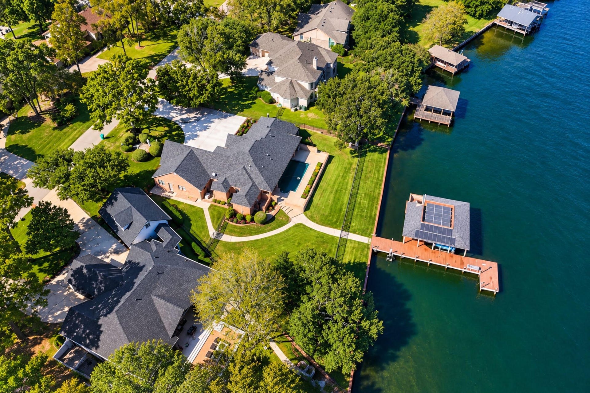9354 Escondido Drive, Willis, TX 77318 Gated, on the lake, with a boat house, a pool, and generator. Your luxury hideaway is calling.