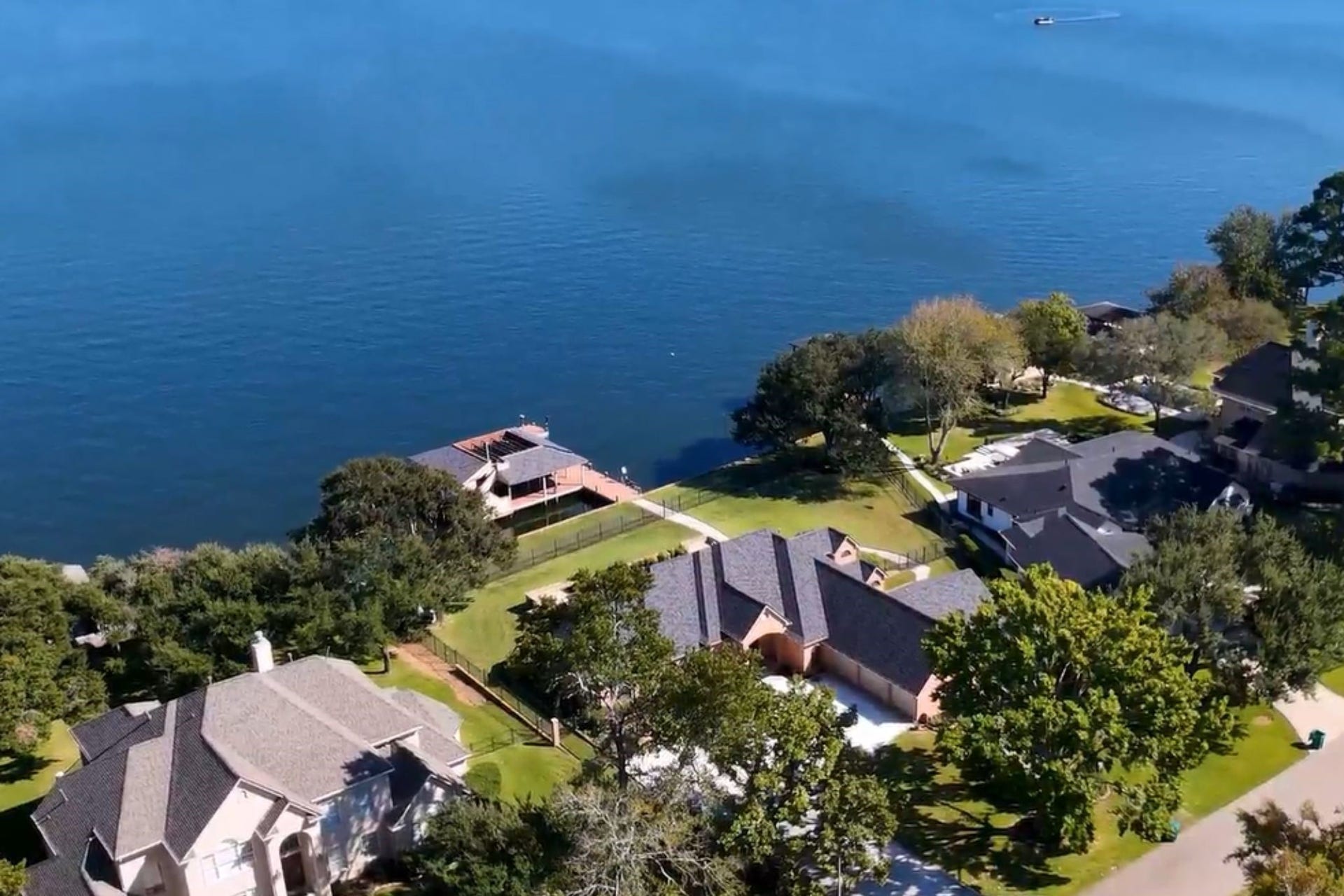 9354 Escondido Drive, Willis, TX 77318 Discover the ultimate Lake Conroe lifestyle! This stunning aerial perspective showcases the home's exceptional peninsula setting, waterfront location and impressive outdoor amenities. Schedule your private showing today!
