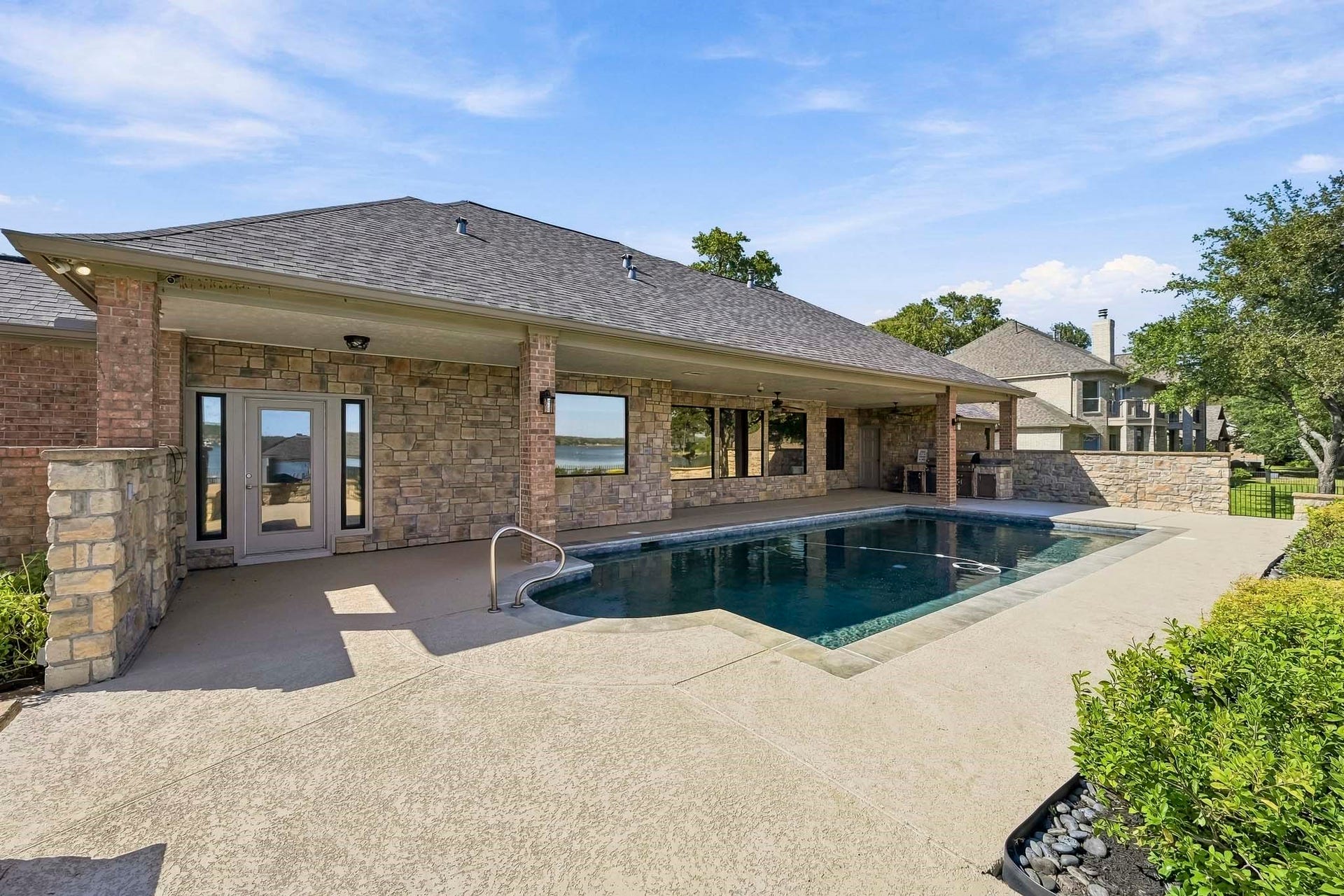 9354 Escondido Drive, Willis, TX 77318 Soak up the sunshine or enjoy refreshing lake breezes! The expansive pool deck offers plenty of space for lounging and outdoor entertaining.