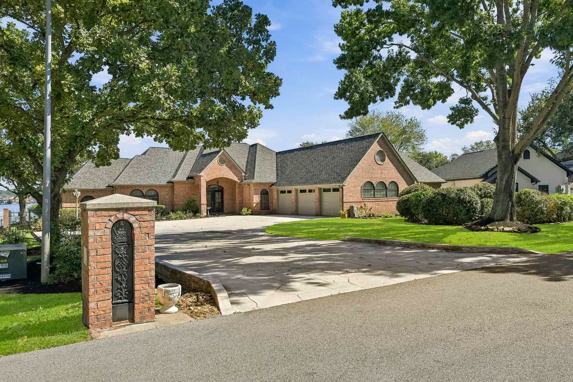 9354 Escondido Drive, Willis, TX 77318 Secluded custom waterfront retreat on a Lake Conroe peninsula in gated Rancho Escondido, positioned on the coveted east sunrise side for spectacular open-water views and refreshing lake breezes!