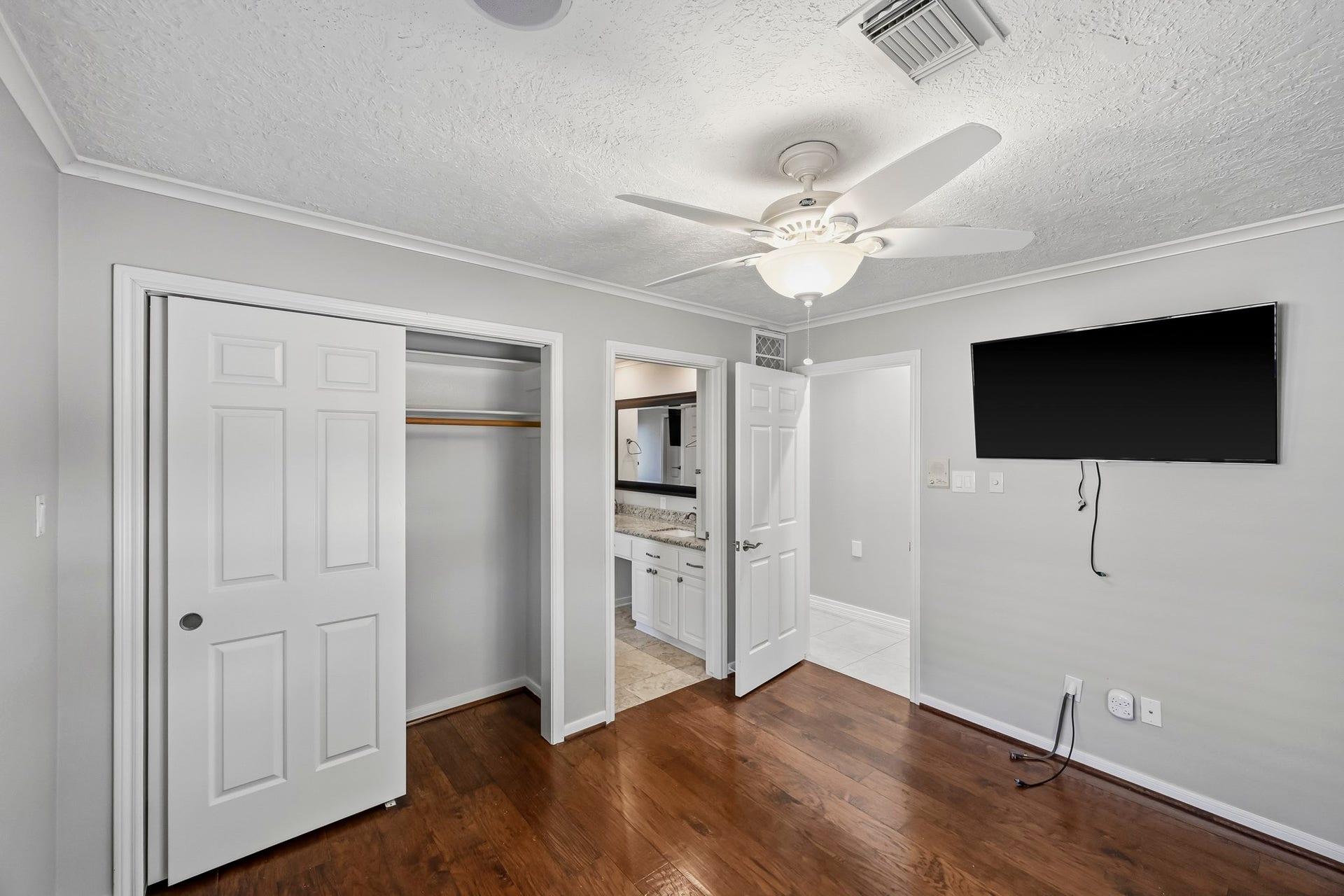 9354 Escondido Drive, Willis, TX 77318 Bedroom #3. Another perspective highlights the bedroom's closet space and convenient access to the adjoining bathroom.