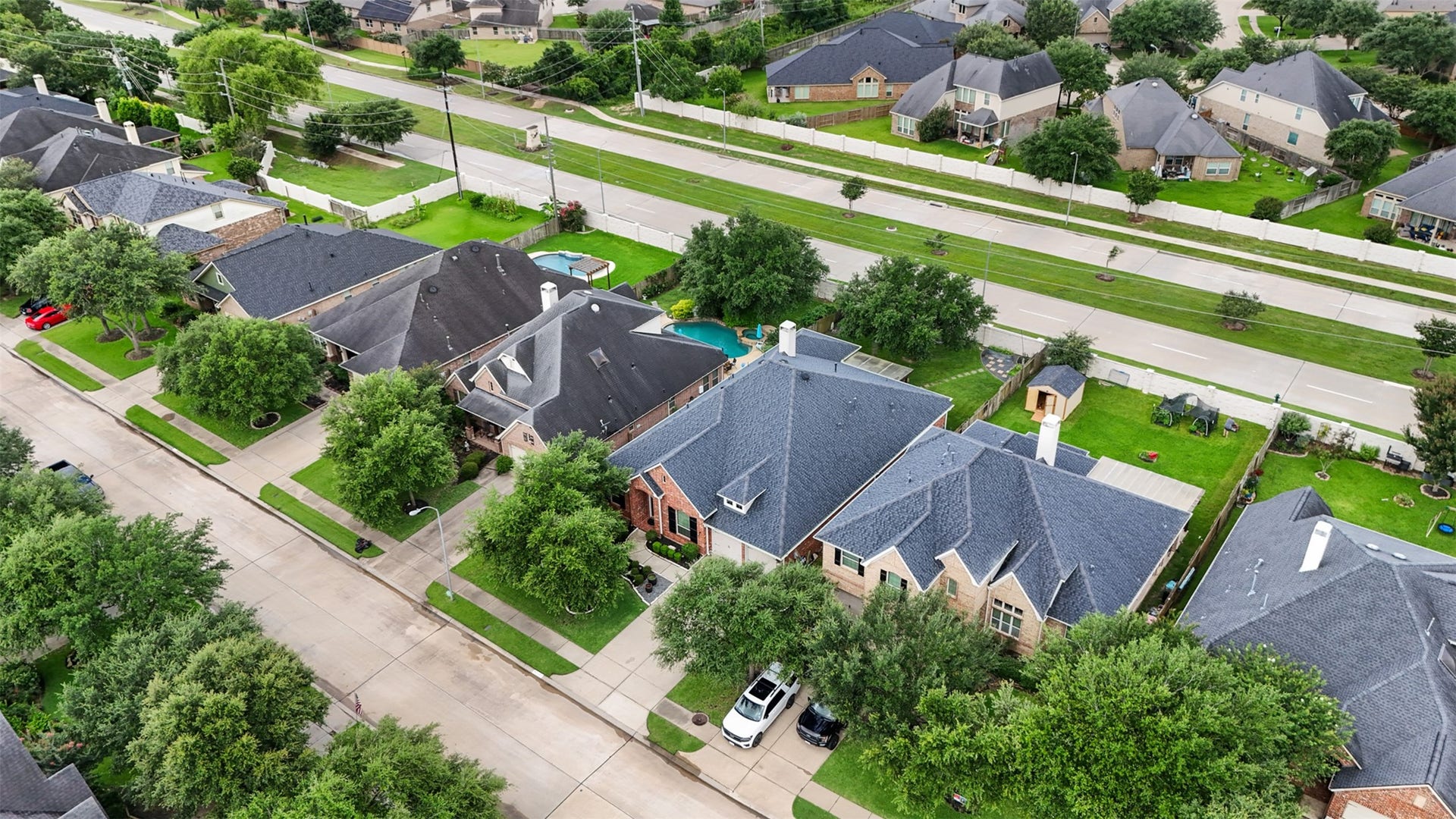 2902 Red Maple Drive, Katy, TX 77494 Aerial views showcase the home's attractive curb appeal and prime location within a beautifully established neighborhood. Mature trees line the streets and surround the property, creating a picturesque setting while highlighting the generous homesite, spacious driveway, and well-maintained surroundings. Conveniently situated near major thoroughfares, shopping, dining, and everyday conveniences, this location offers the perfect balance of accessibility and neighborhood charm.