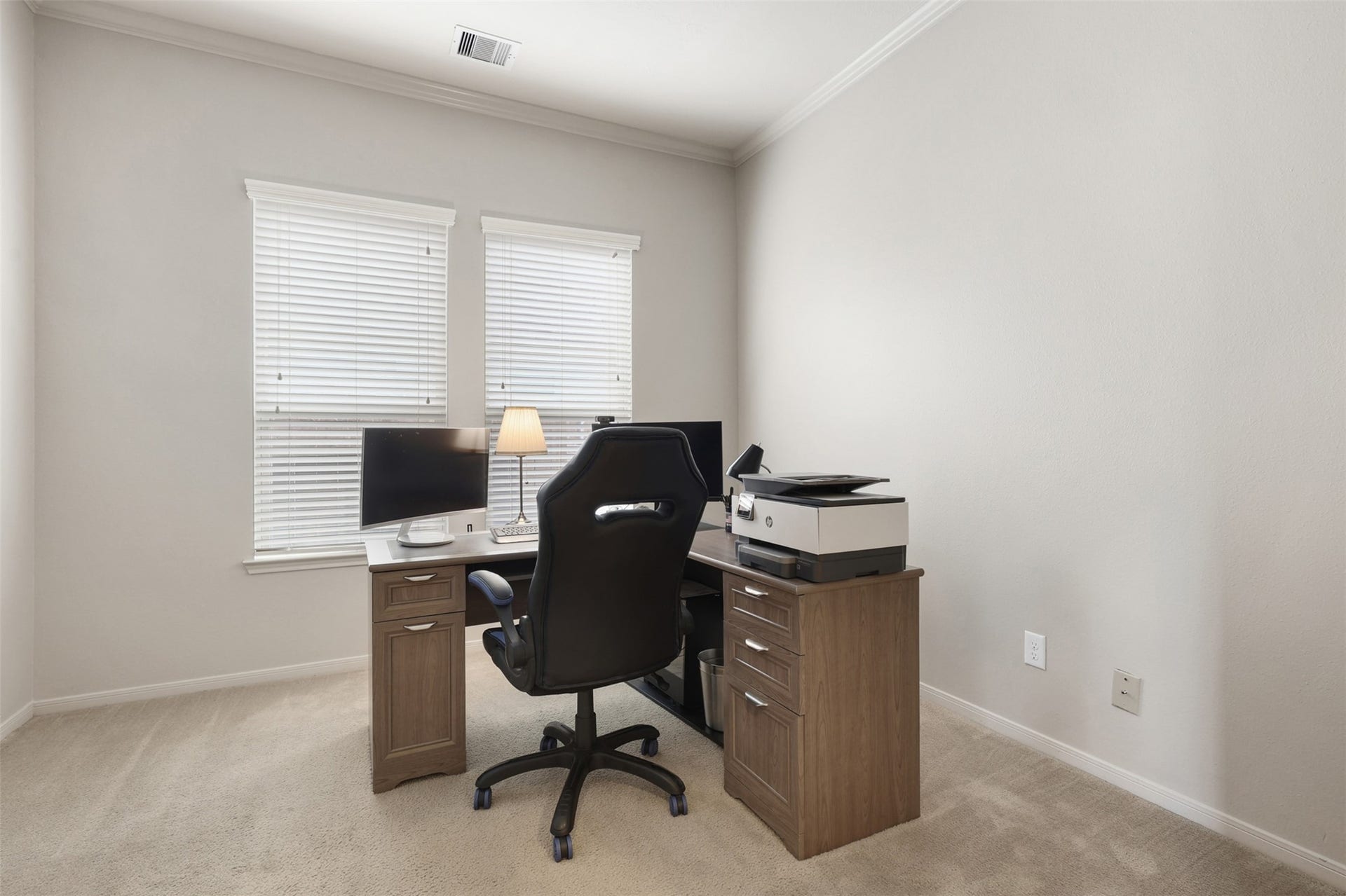 2902 Red Maple Drive, Katy, TX 77494 This spacious home office features crown molding, plush carpeting, and dual windows that fill the room with natural light. The flexible layout easily accommodates a dedicated workspace while offering versatility for a study, hobby room, or additional living area.
