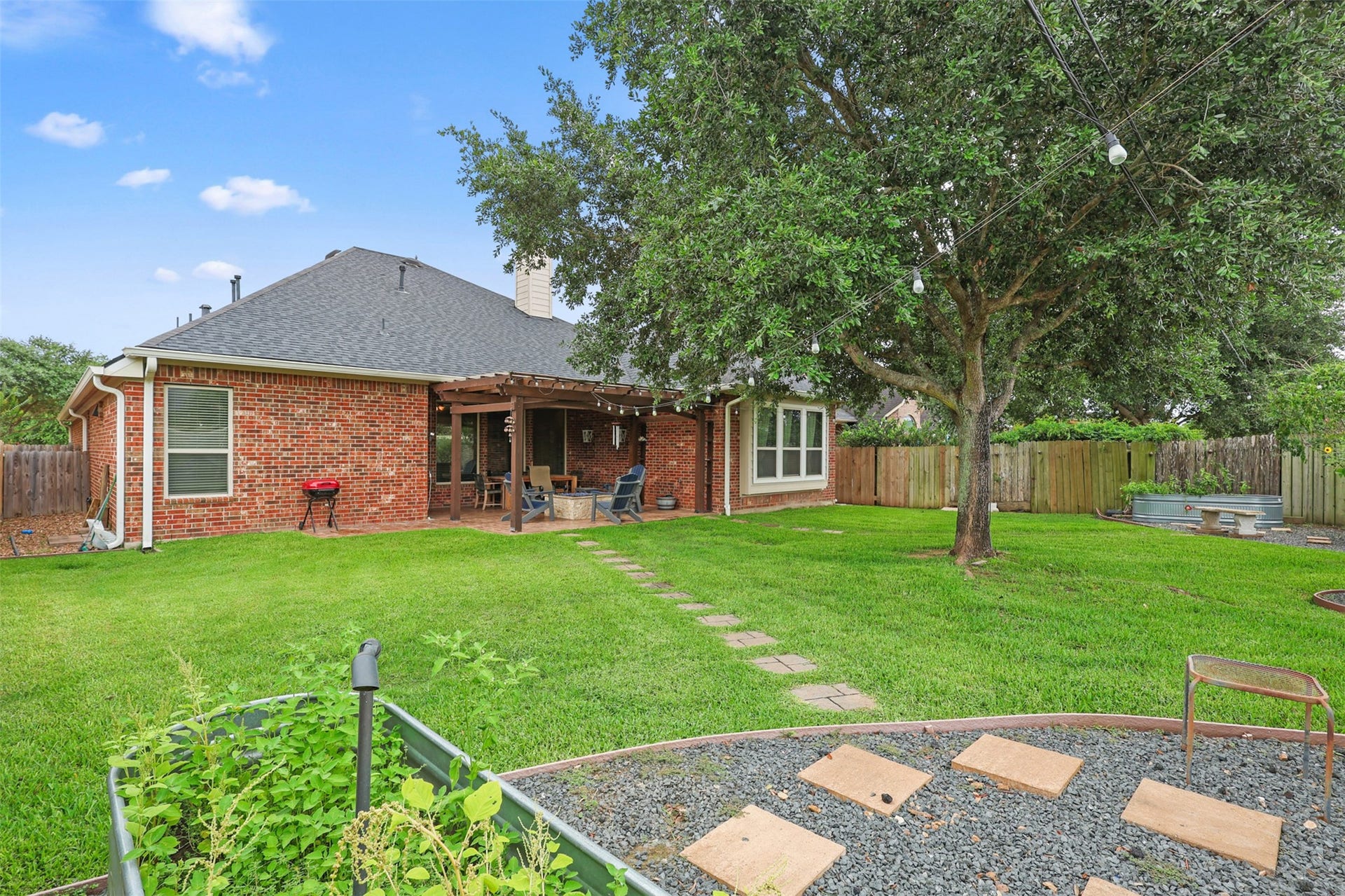 2902 Red Maple Drive, Katy, TX 77494 Mature trees provide natural shade while the expansive grassy area offers endless possibilities for recreation, gardening, or future outdoor amenities.