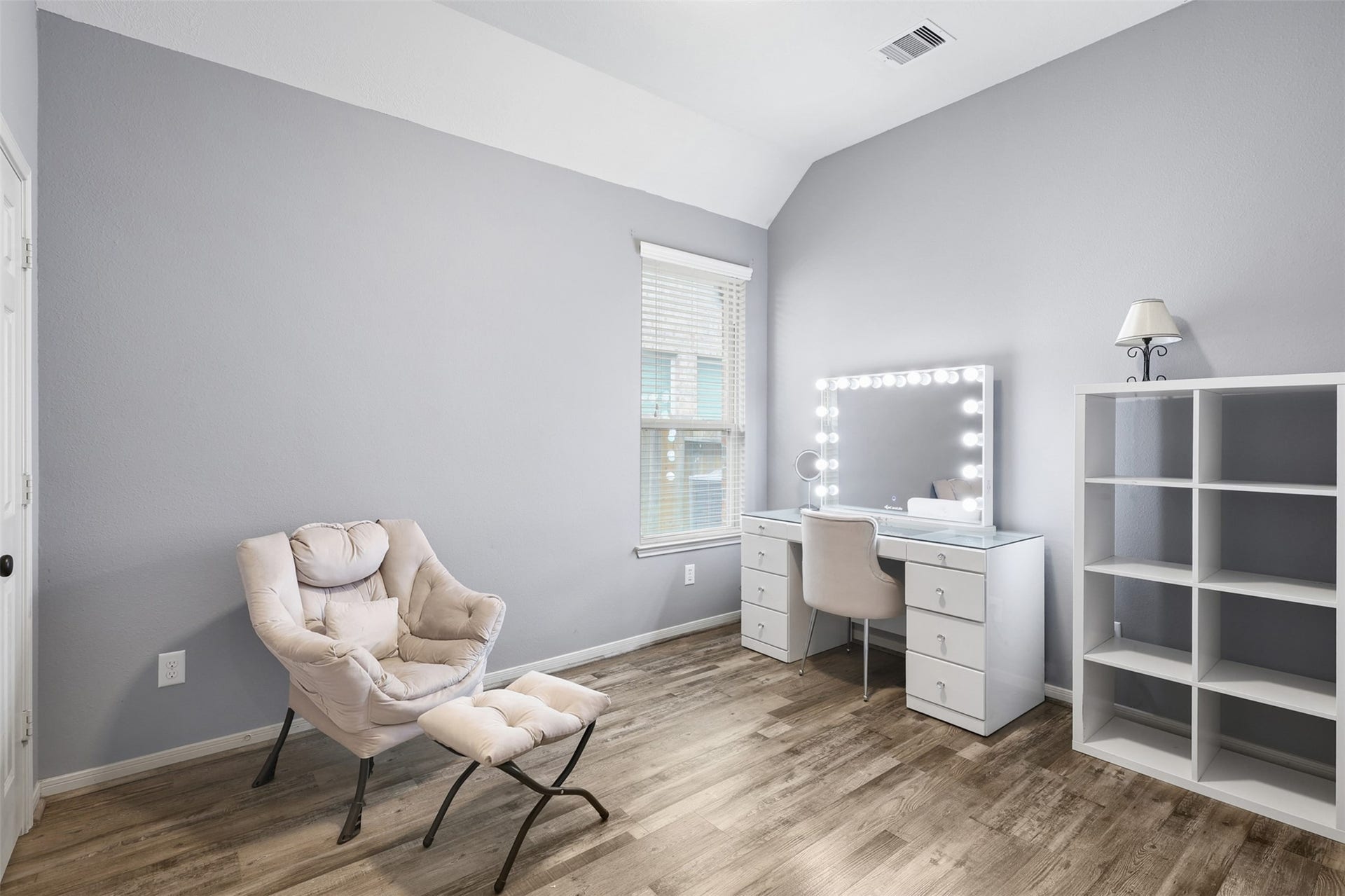 2902 Red Maple Drive, Katy, TX 77494 This charming secondary bedroom features soaring vaulted ceilings, attractive wood-look flooring, soft designer paint, and a bright window that fills the room with natural light.