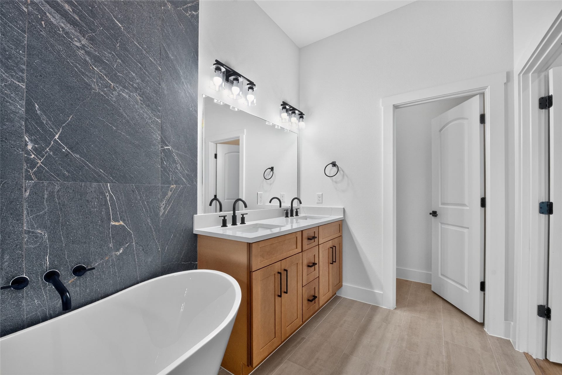 3537 Amos Street, Houston, TX 77021 A beautifully finished primary bath centered around a deep soaking tub and dual vanities offers a sophisticated space to begin and end the day.