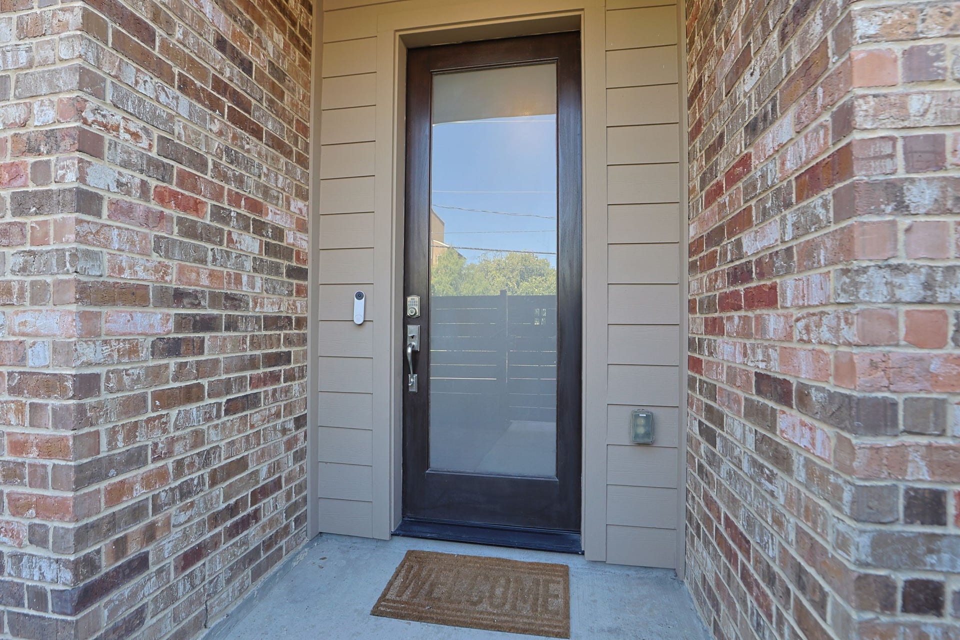 4515 Cornish Street, #A, Houston, TX 77007 Solid wood modern front door with glass and a keyless entry. Guests are covered from the rain at your entrance!