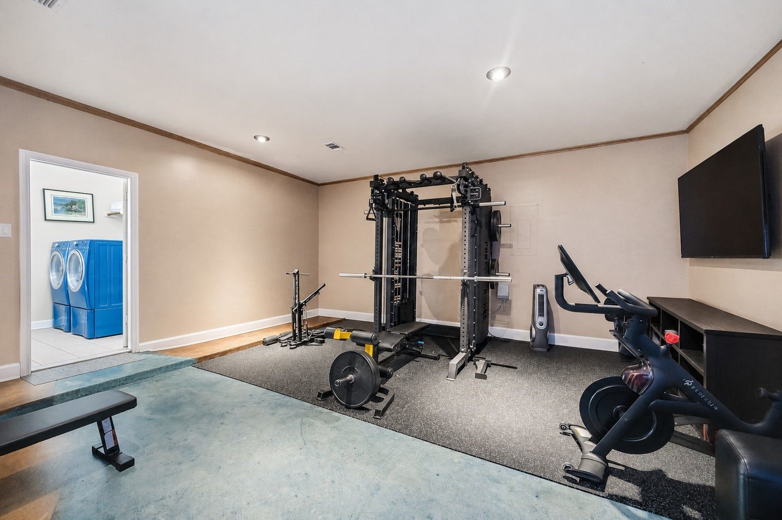 7610 Guinevere Drive, Sugar Land, TX 77479 This multi-purpose bonus space can easily be used as a gym area or tailored to your preference, featuring recessed lighting, durable concrete-style flooring, and a wide doorway connecting to the laundry room.