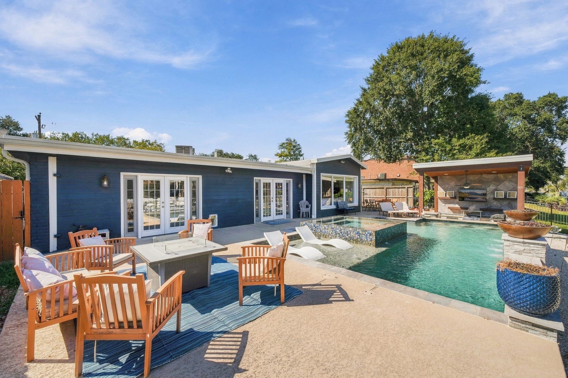 10 Harbor Lane, Kemah, TX 77565 This backyard oasis offers spacious patio seating, and a modern outdoor kitchen, and firepit for those cool crisp evenings.