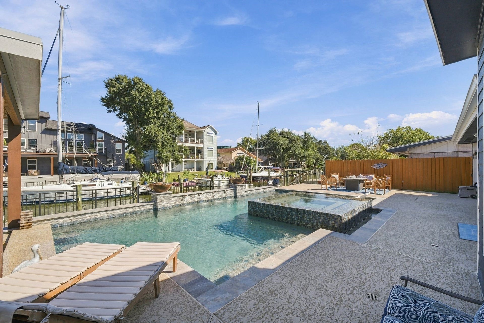 10 Harbor Lane, Kemah, TX 77565 Lounge by the pool or take your boat to the lake. This home has a stunning pool and spa, spacious patio, and direct dock access for boating adventures.