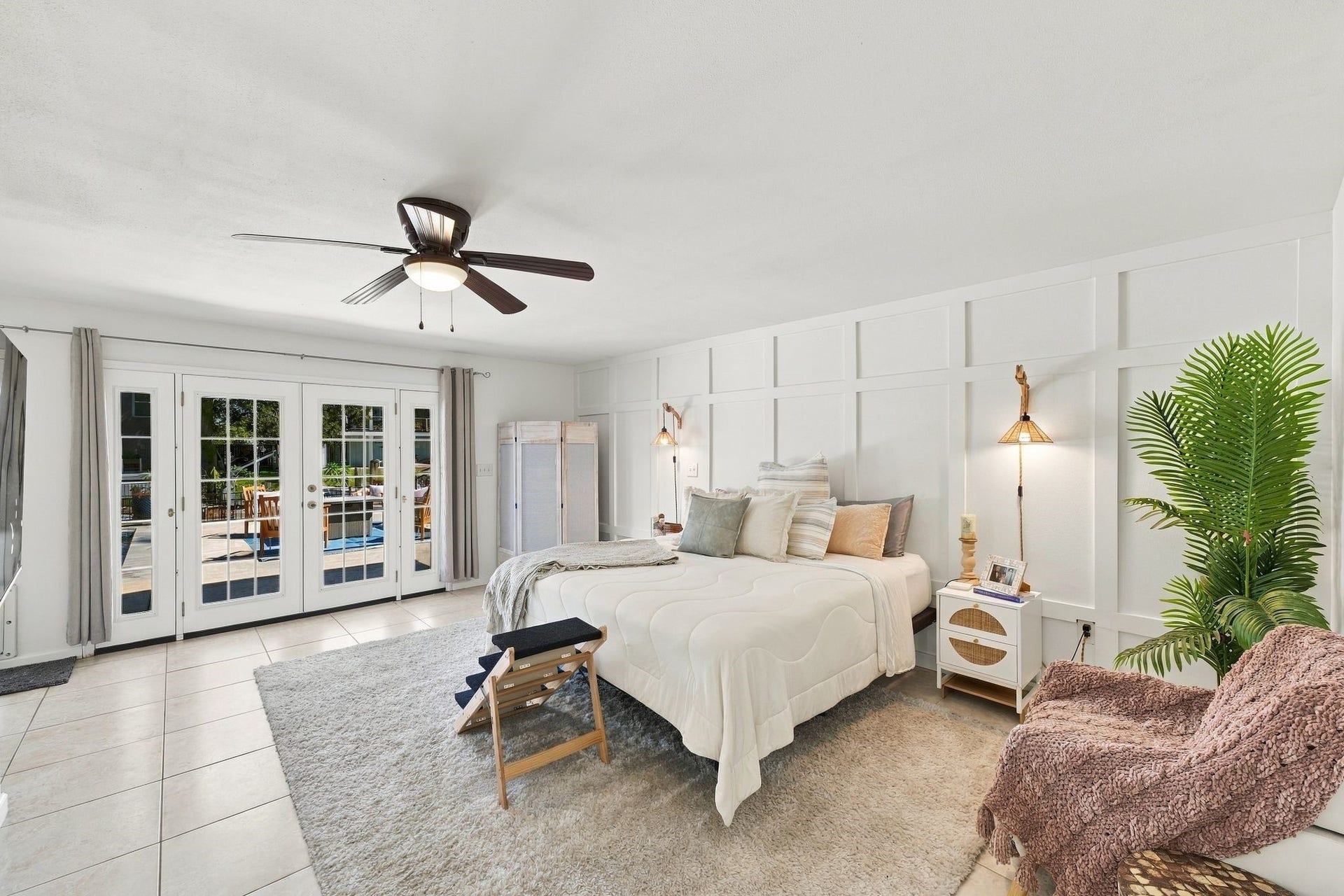 10 Harbor Lane, Kemah, TX 77565 The spacious first-floor primary suite offers a peaceful waterfront retreat, featuring elegant French doors that open to a sunlit patio with beautiful water views. Two generous walk-in closets provide ample storage, adding comfort and convenience to this inviting private sanctuary.