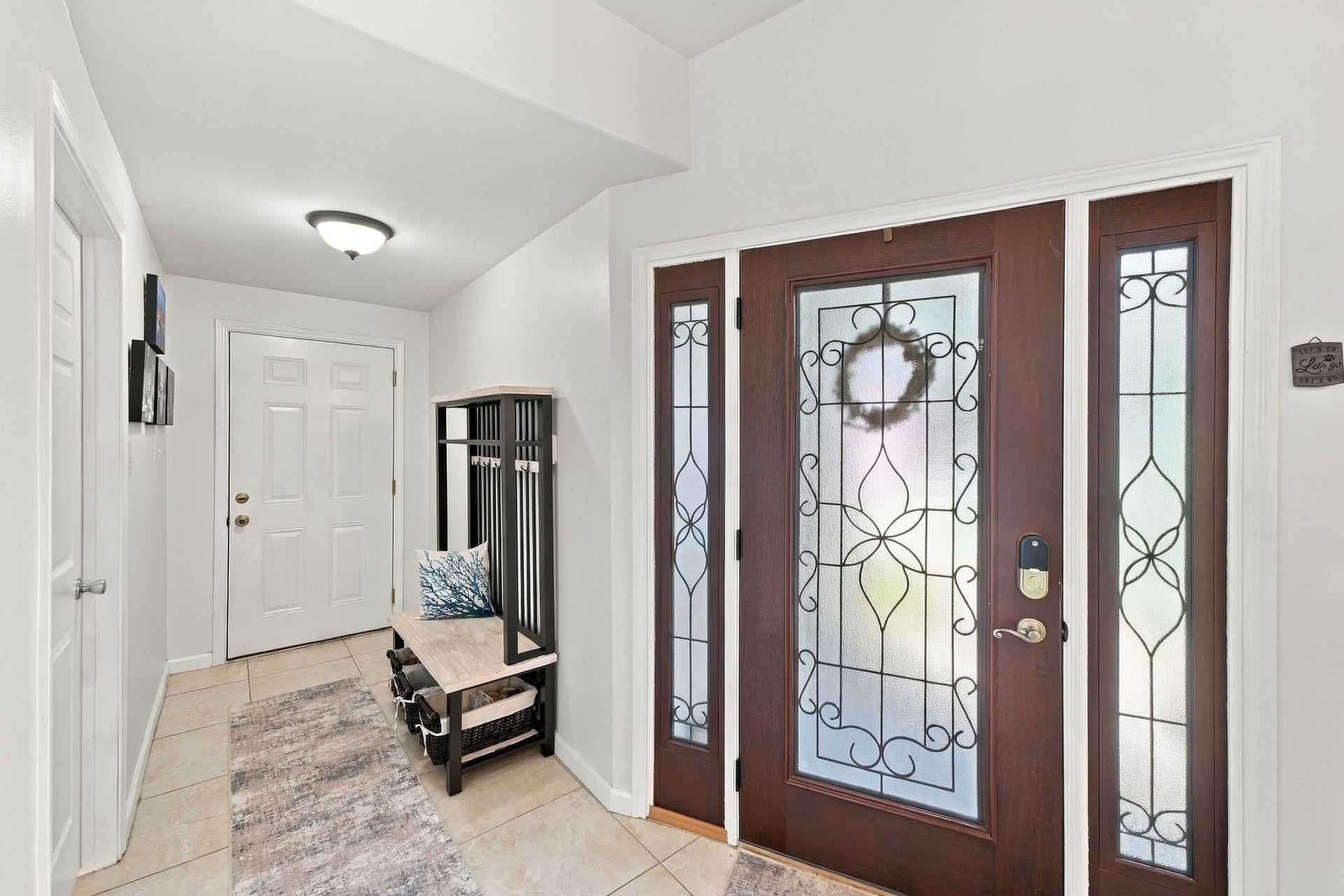 10 Harbor Lane, Kemah, TX 77565 Welcoming entryway featuring elegant glass-paneled double doors that fill the space with natural light. This versatile area offers the perfect opportunity to create a functional mudroom, with convenient access to the garage.