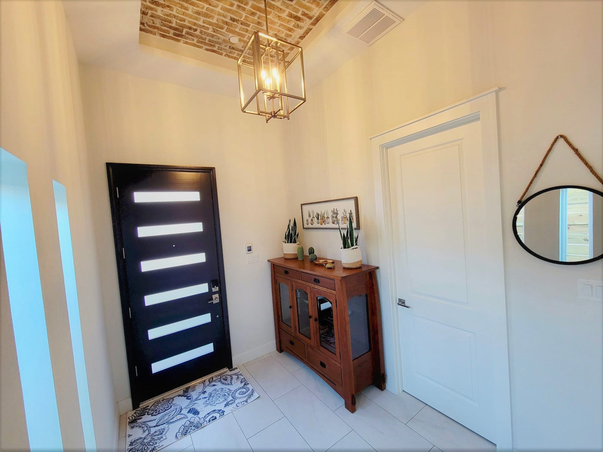 Charming entry foyer with brick ceiling design. Soaring 12 ft ceilings!